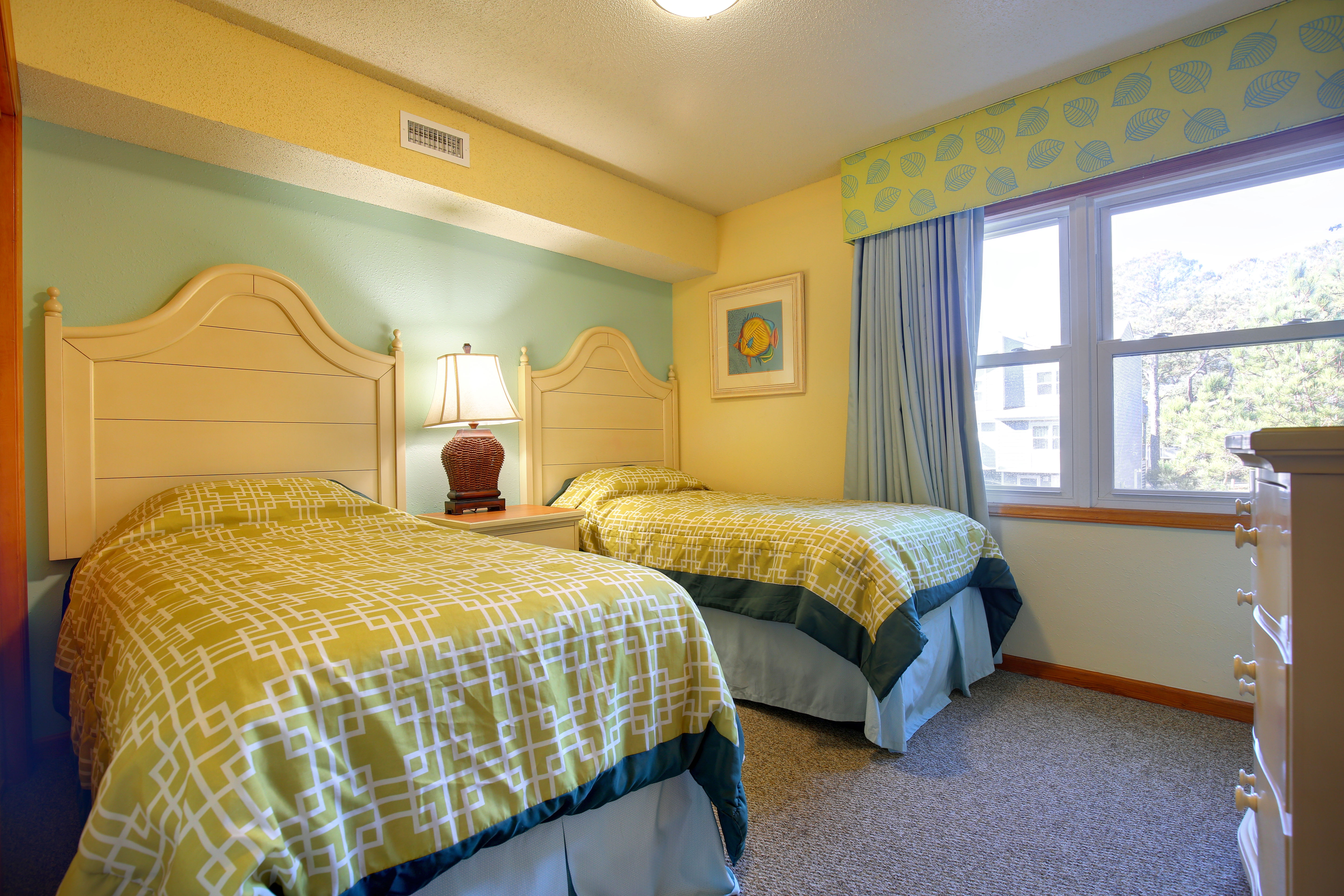 image The cozy bedroom is adorned with soft pastel hues and comfortable twin beds, providing a serene retreat for restful nights.