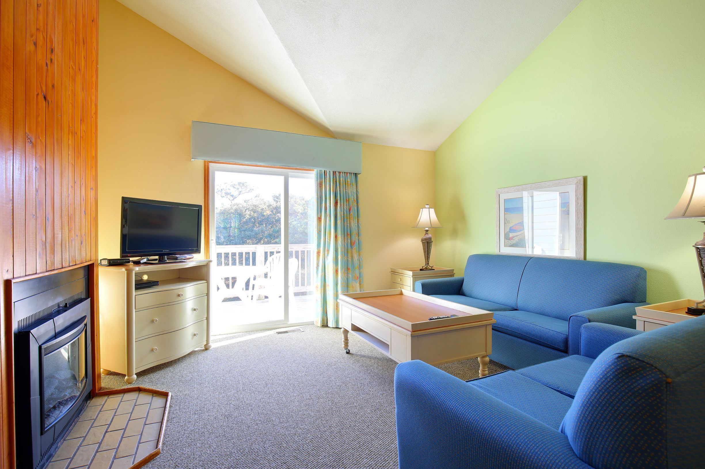 image Relax in the cozy living room featuring a fireplace, comfortable seating, and a view of your own balcony.