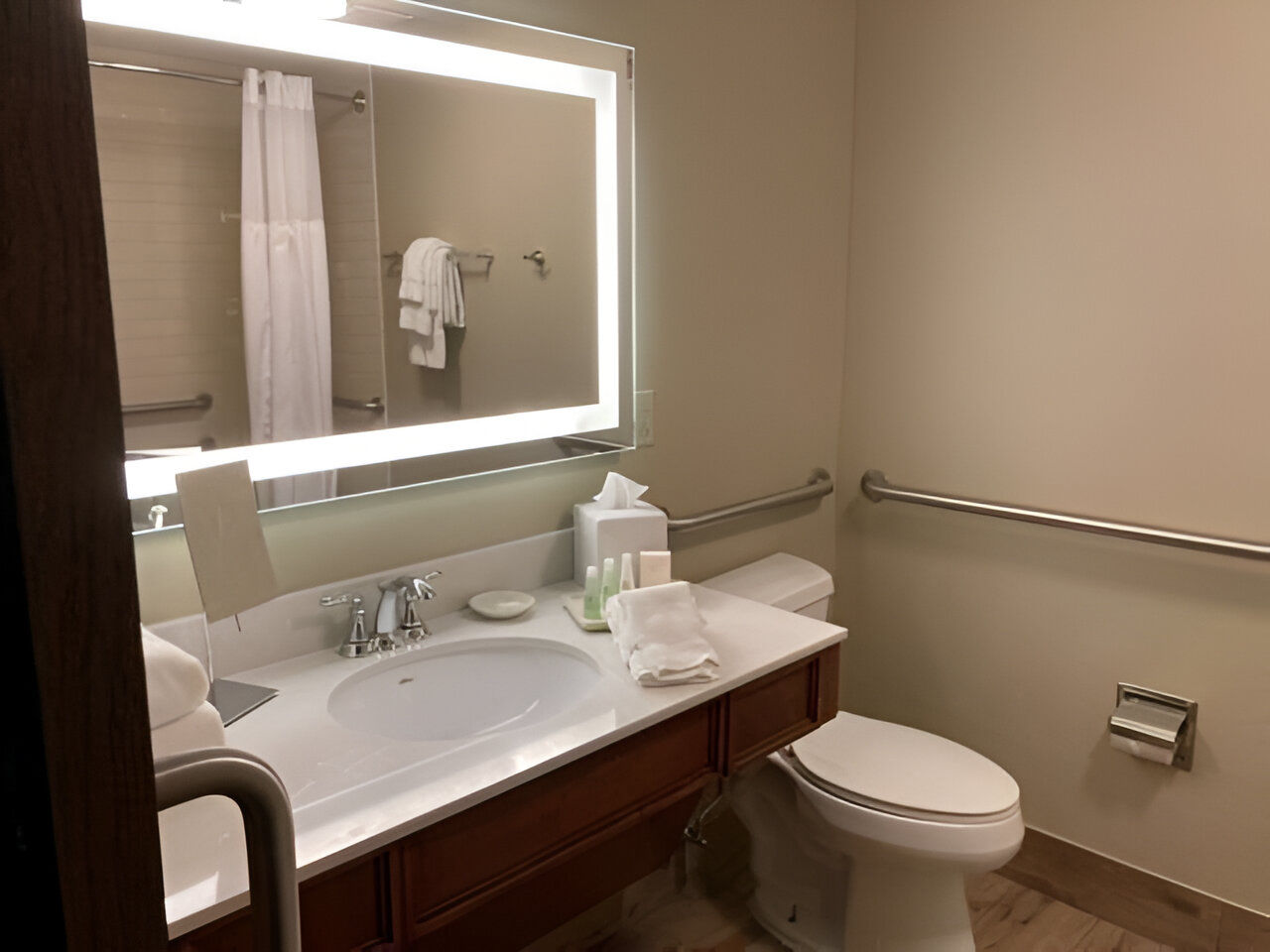image Spacious vanity and soft lighting create a peaceful and accessible space to refresh and prepare for the day.