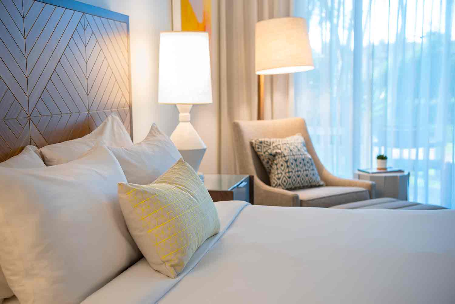 image Settle into layered comfort where plush pillows, warm light, and peaceful textures invite deep rest.