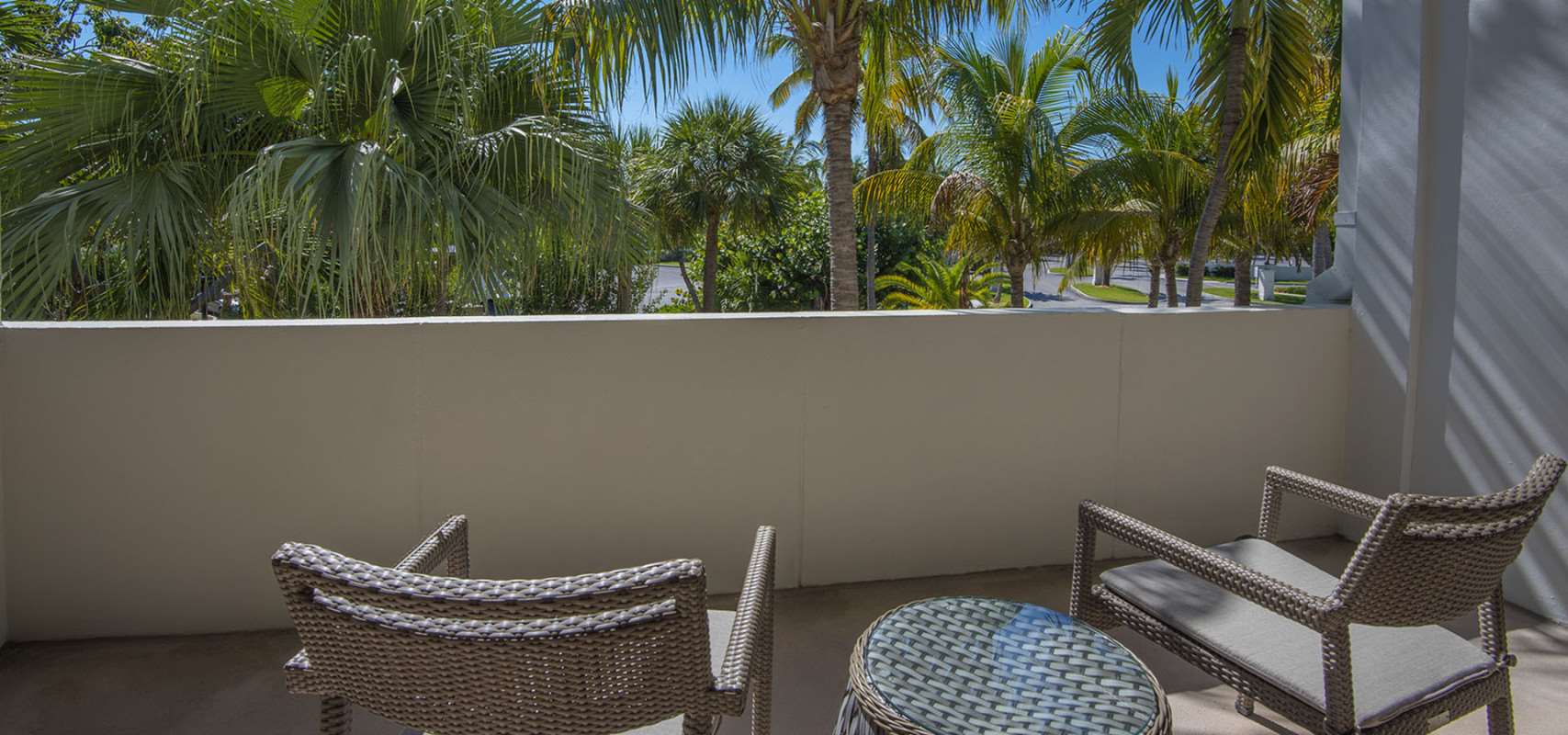 image Start the day with a quiet coffee or wind down beneath the palms—this private balcony invites slow, sunny moments.