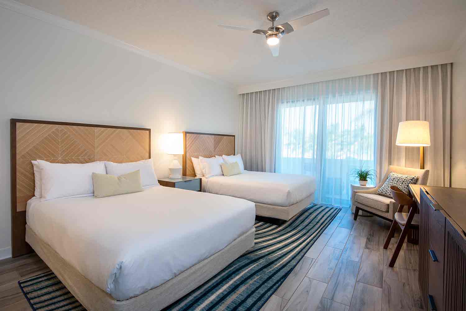 image Ease into island rhythm in a spacious retreat where breezy curtains, natural tones, and cozy textures welcome you in.