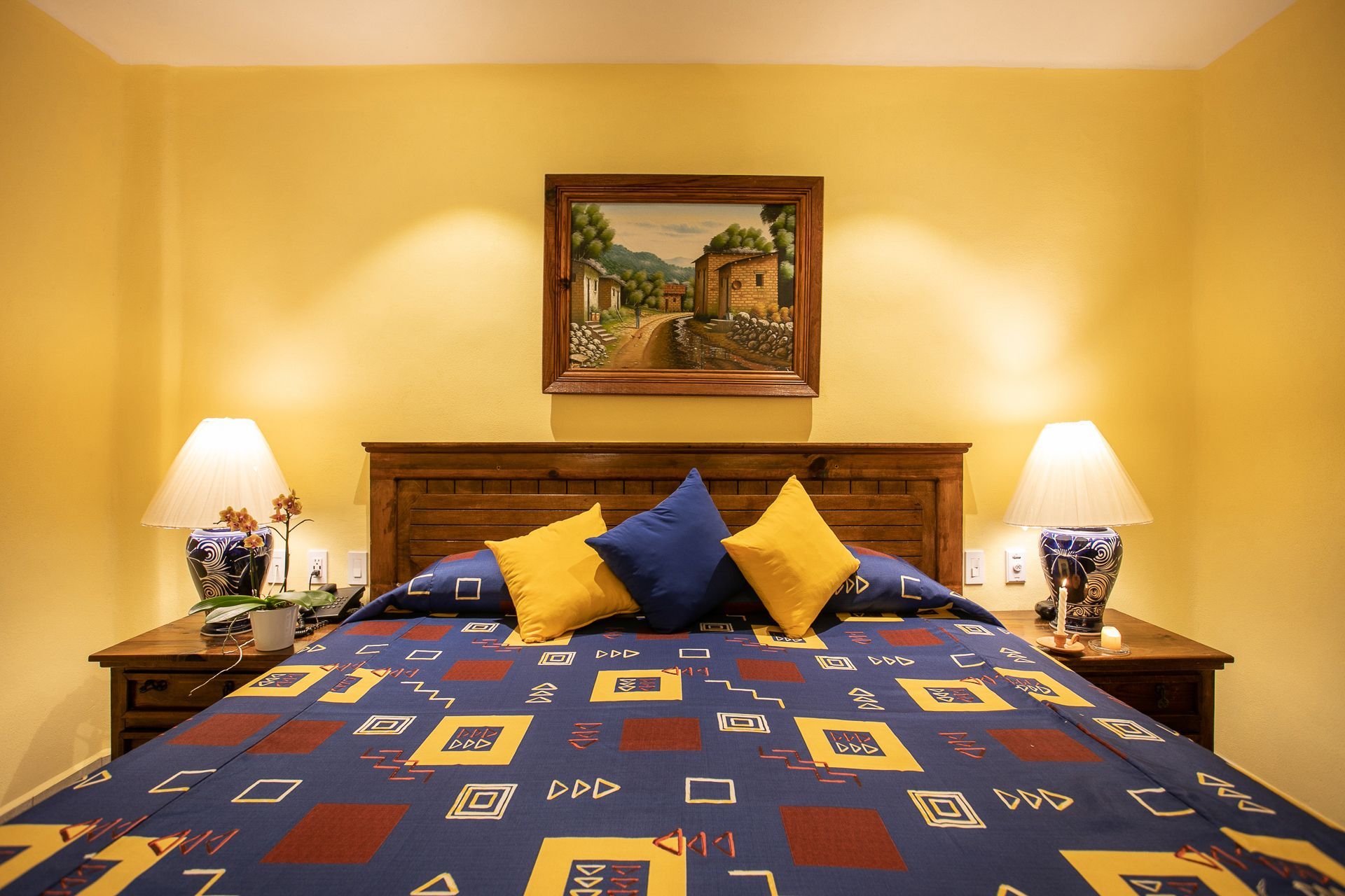 image This charming bedroom provides a relaxed ambiance with carefully chosen decor, including a picturesque painting that complements the traditional style.