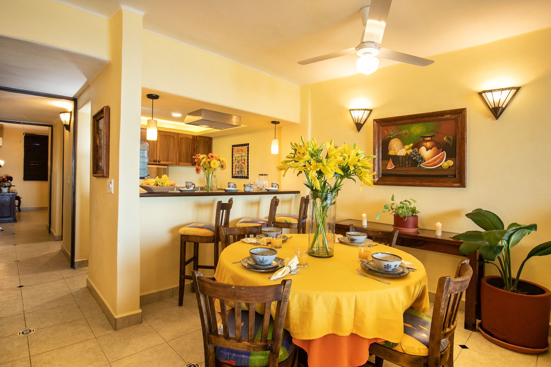 image Gather around the dining table in the spacious full kitchen, featuring bright decor and ample seating for enjoying meals with family and friends.