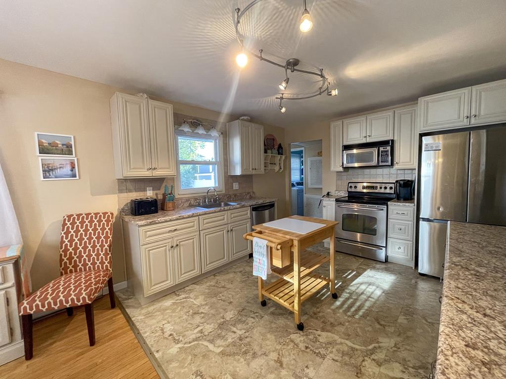 image A chef's delight, this kitchen combines functionality with charm, ensuring every meal shared creates lasting memories within these four walls.
