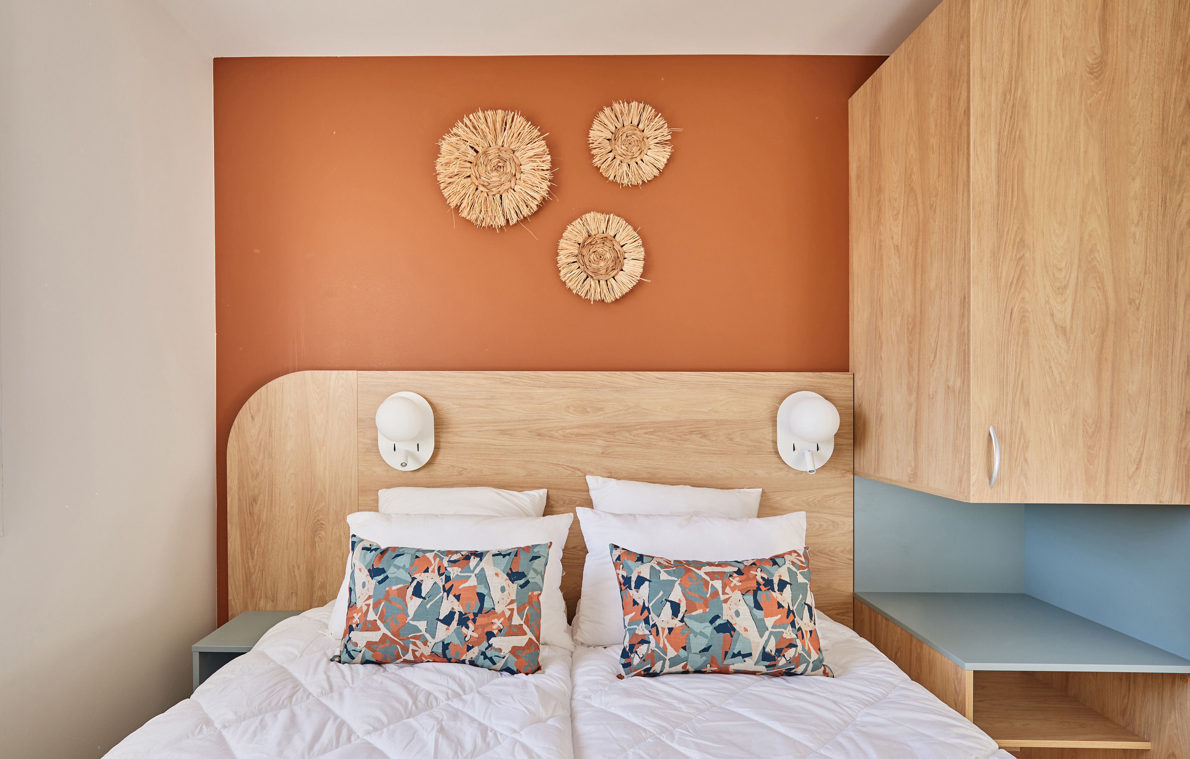image The tranquil bedroom showcases stylish decor with warm tones and plush bedding, creating a restful retreat just minutes from the beach.