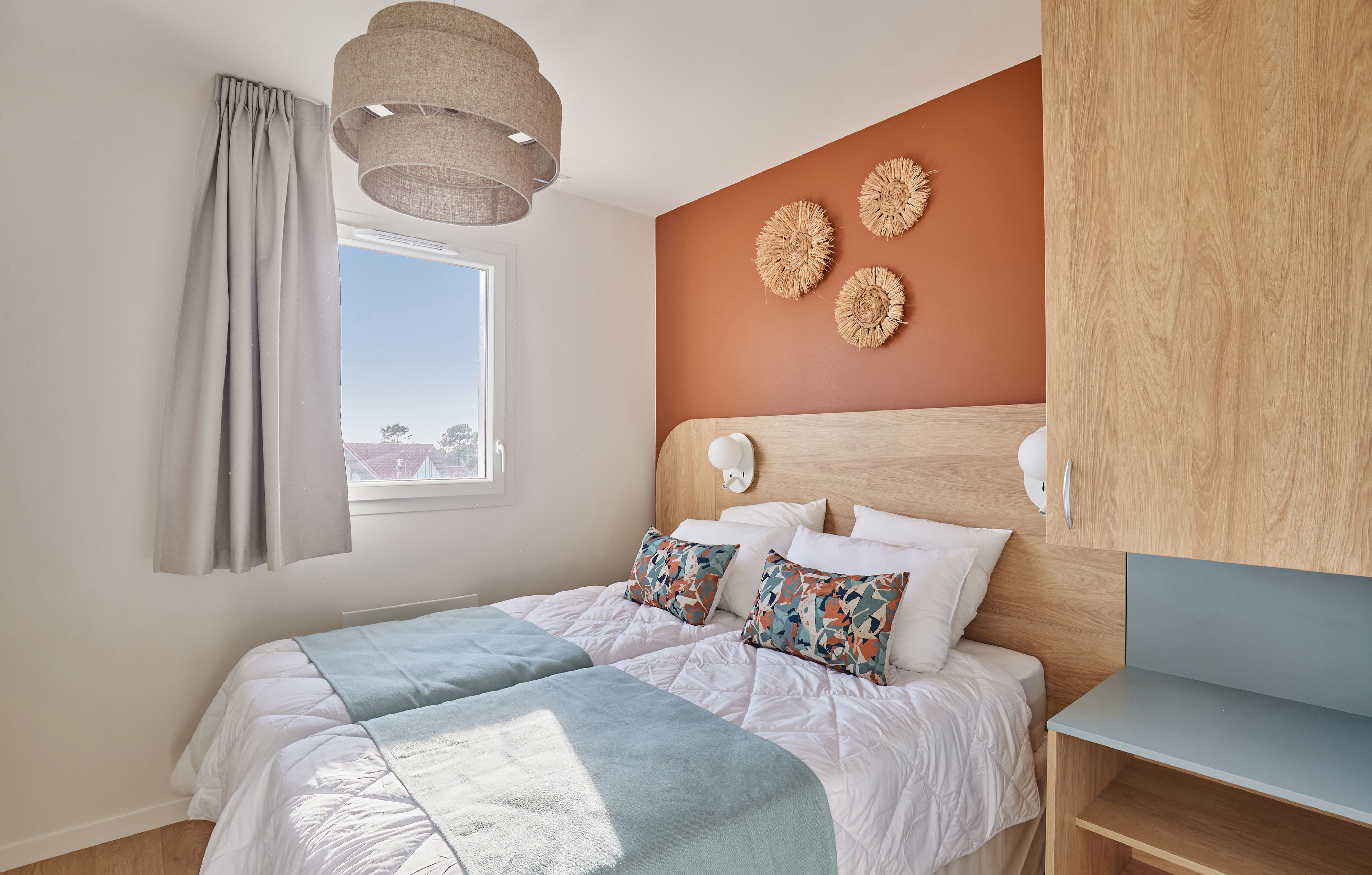 image Relax in the inviting bedroom adorned with stylish decor and natural light, providing a serene retreat after a day of enjoying the beach and community amenities, including a fitness room.