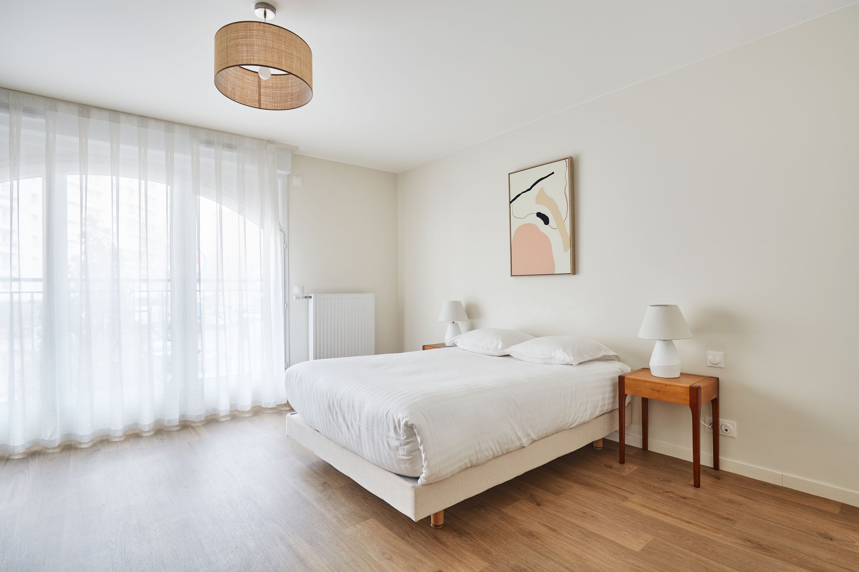 image Compact yet inviting sleeping and dining space, framed by large windows and soft lighting.