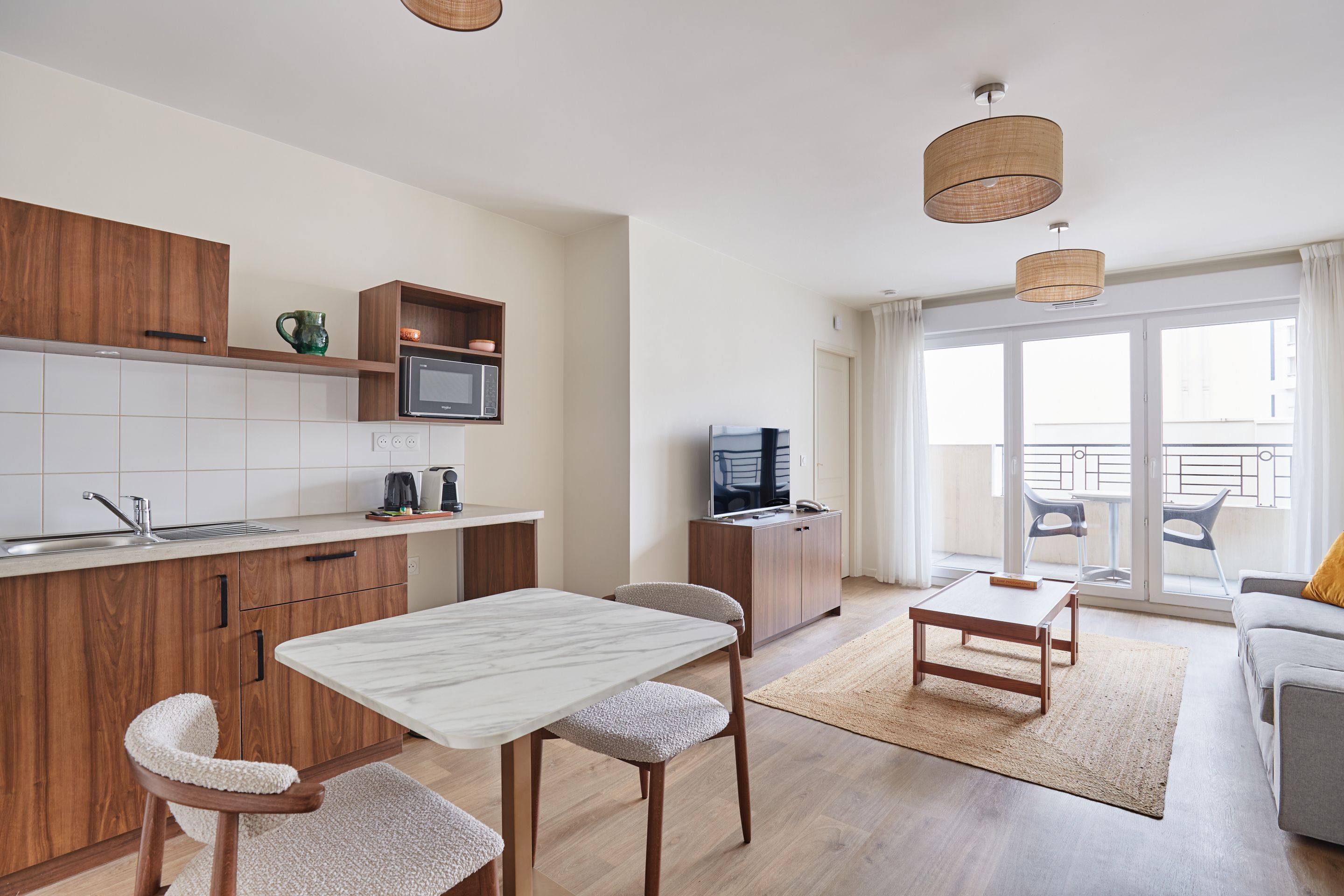 image Bright open-plan apartment with a fully equipped kitchenette, perfect for enjoying home-cooked meals just minutes from Paris.