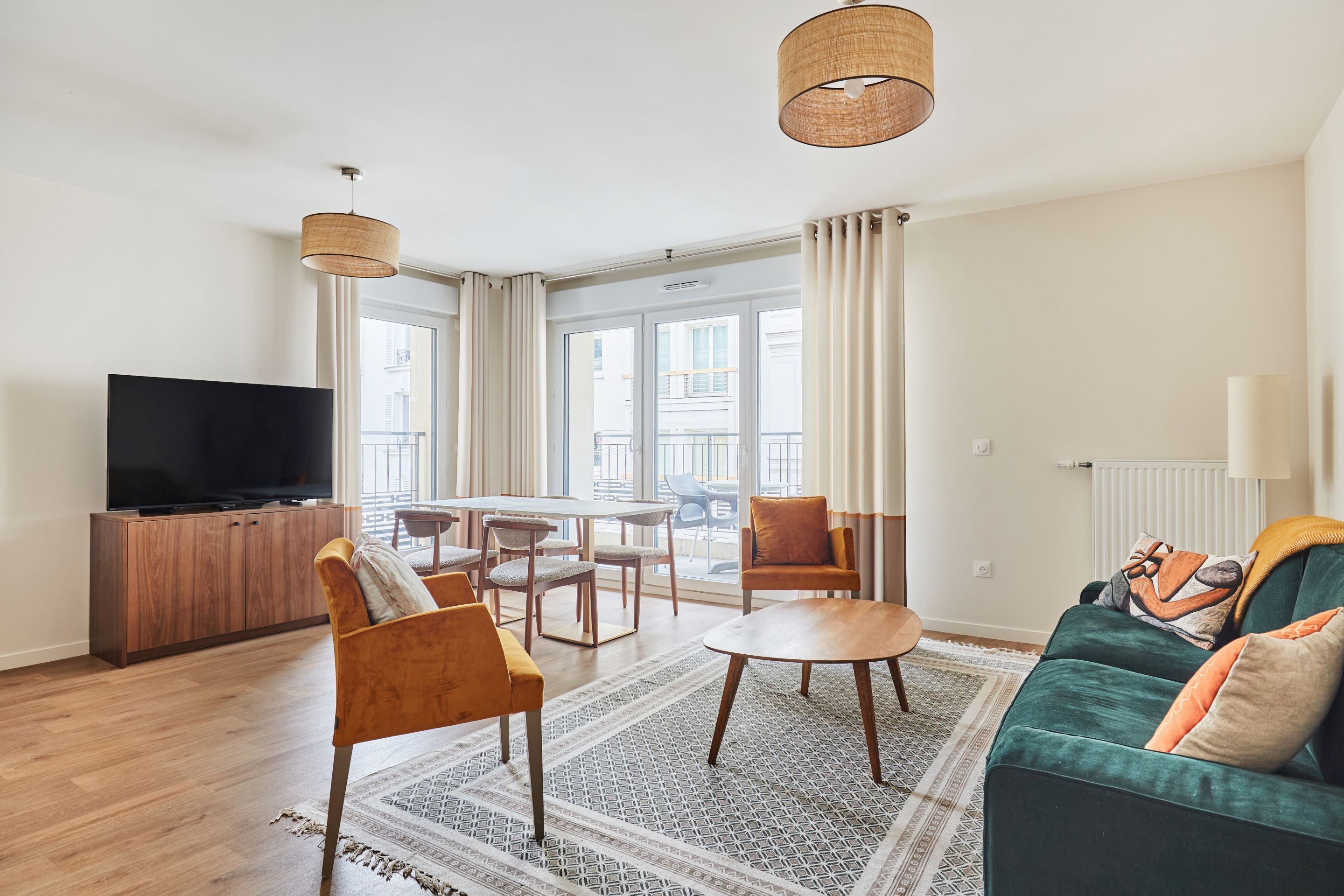 image Spacious living area featuring comfortable decor, elegant seating, and access to the balcony—ideal for quality time with friends or family.
