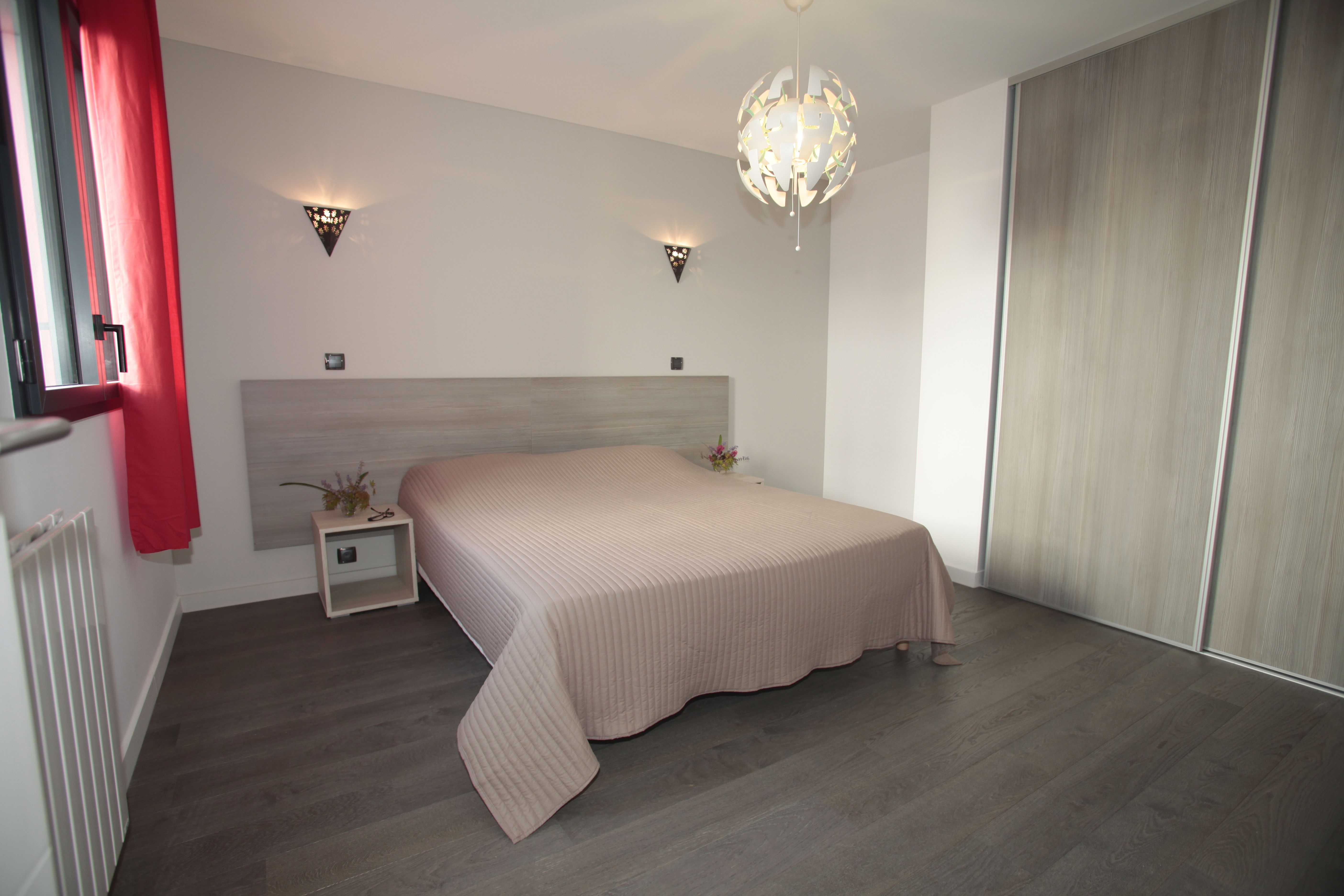 image Bright and serene bedroom with plush bedding and direct access to natural light through large windows.