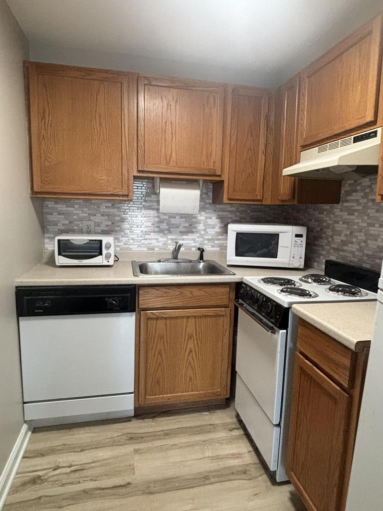 image A compact yet efficient kitchen with sleek countertops and essential appliances, designed to blend comfort and functionality for your seaside escape.