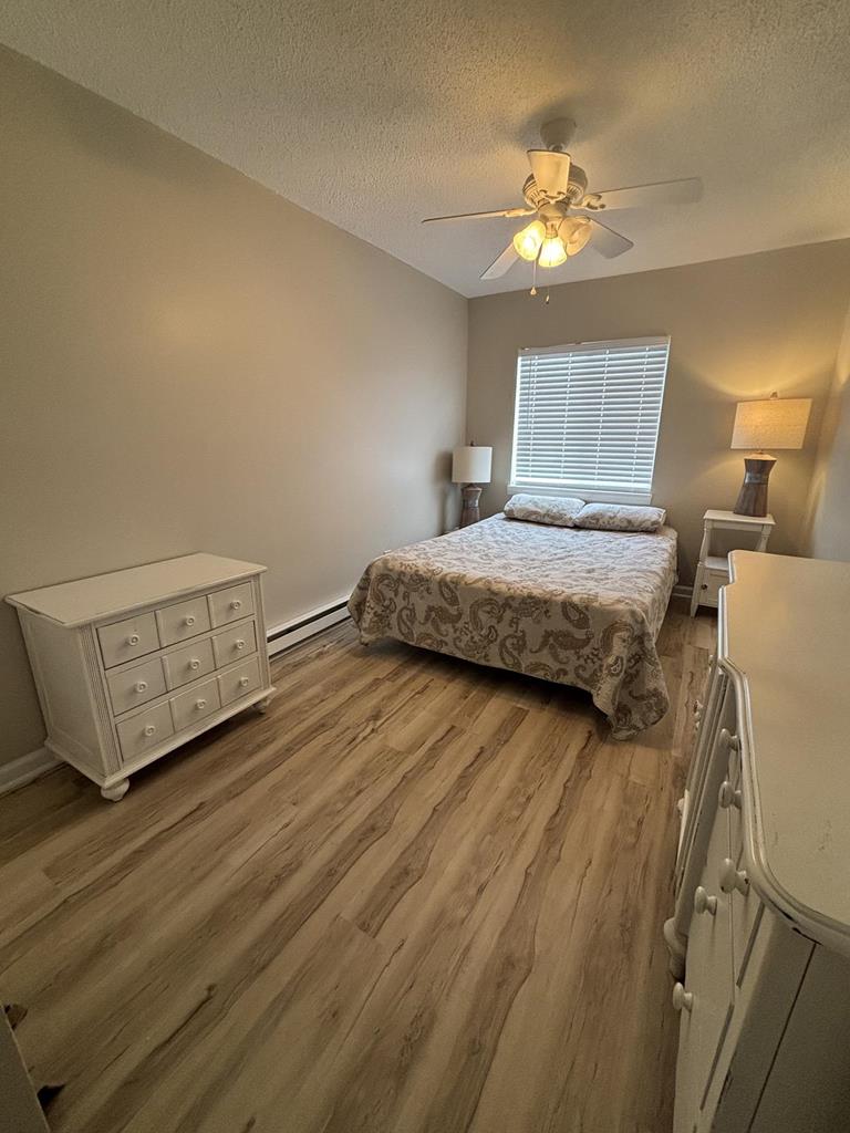 image A tranquil master bedroom features a plush queen bed, tasteful decor, and warm lighting, providing a perfect retreat after a day of beach fun.