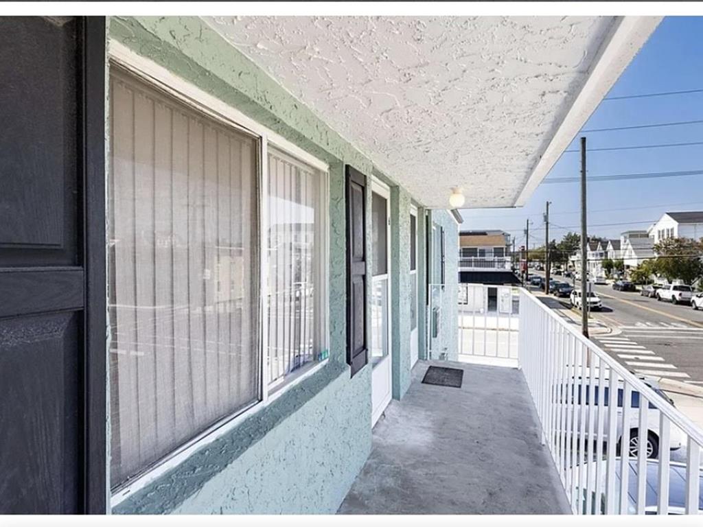image Enjoy the sea breeze on your private porch, just a short stroll away from the pristine Wildwood Crest beach.
