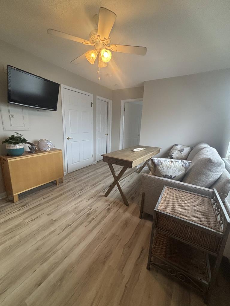 image The cozy living area features a smart TV and comfortable seating, perfect for family relaxation after a beach day.