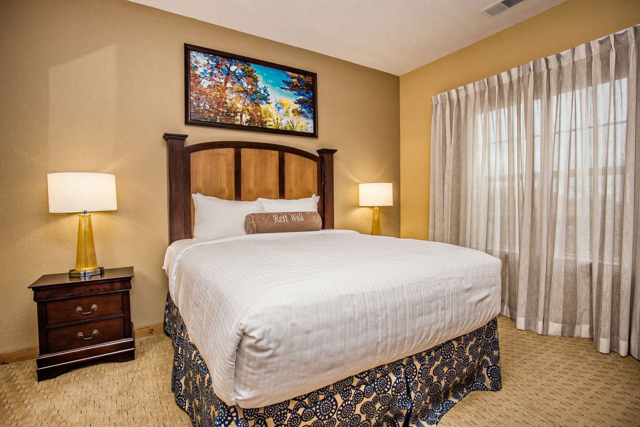 image Second bedroom with queen bed, flat-screen TV, and natural light from large windows.