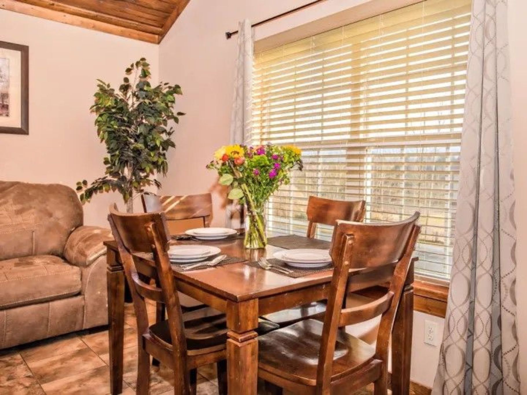 image Dining area beside the window, offering plenty of light and a cozy atmosphere.