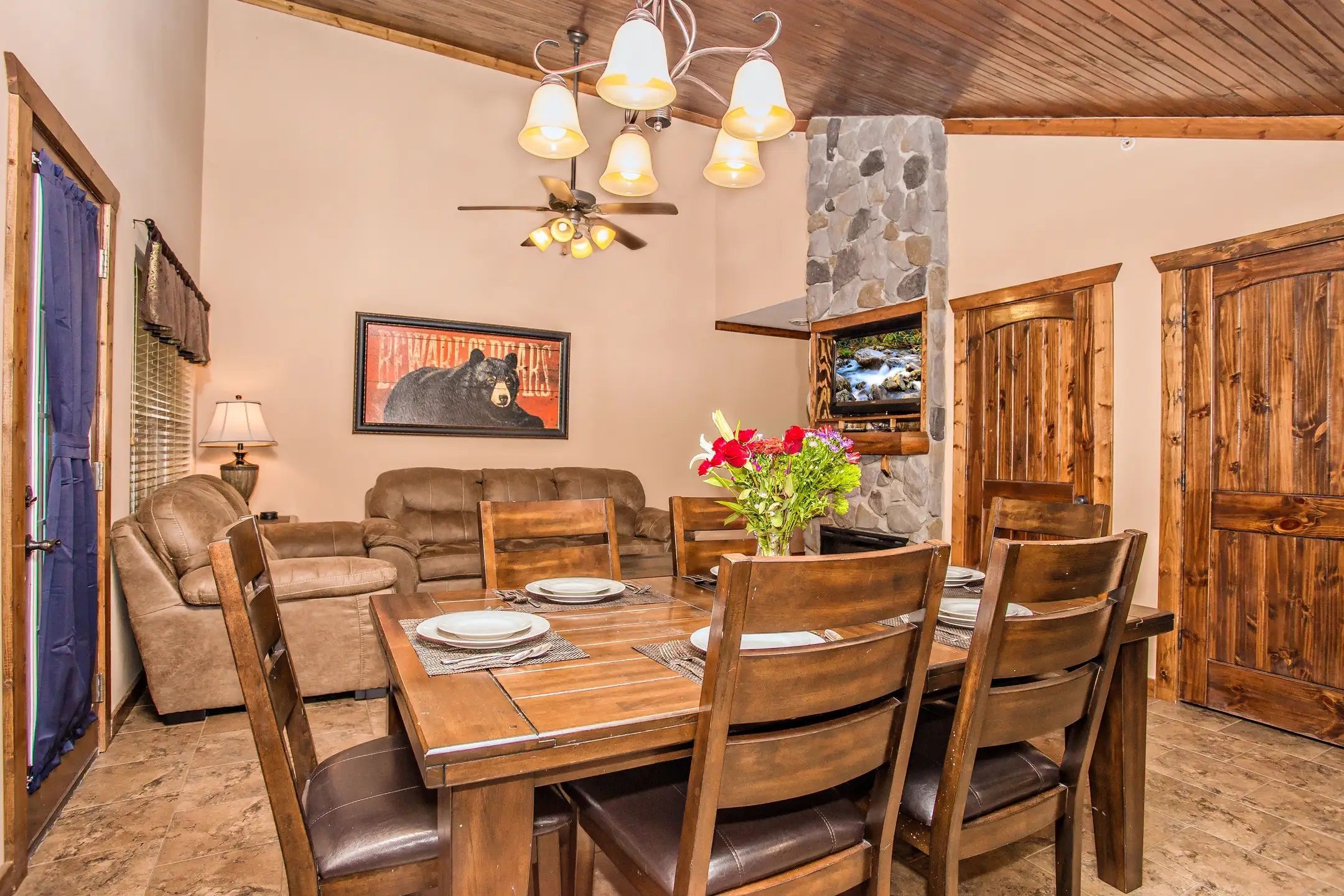 image Dining area with wooden table and chandelier lighting.