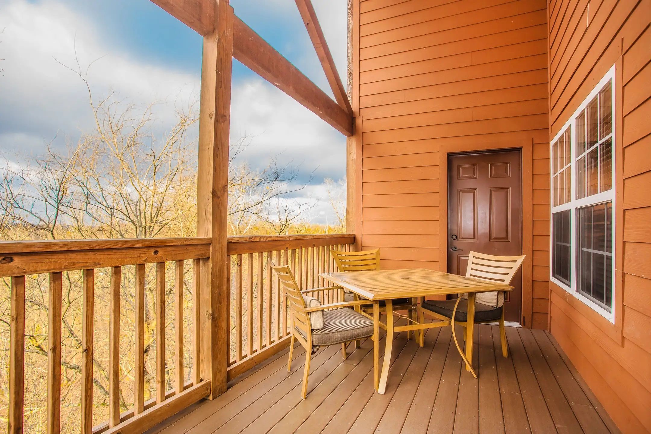 image The unit has a private balcony with table and chairs overlooking the surrounding scenery.
