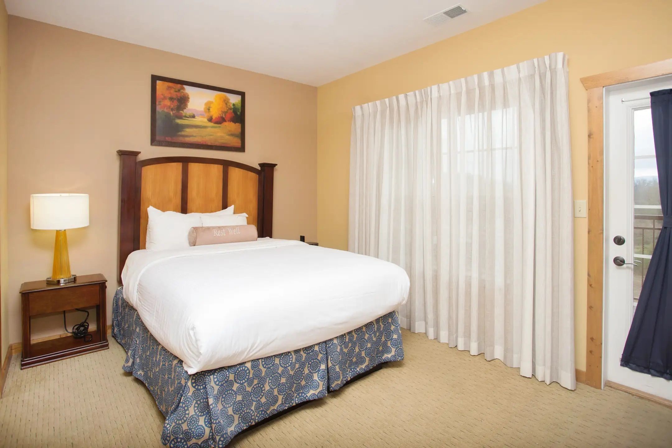 image Bedroom with king bed, soft lighting, and direct access to the balcony.