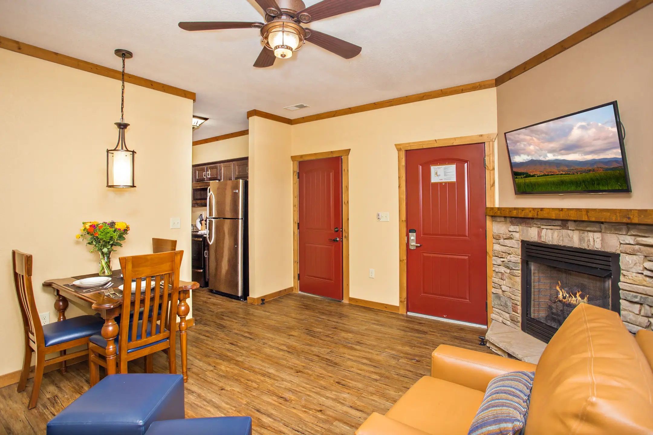 image Living room with fireplace, flat-screen TV, and comfortable seating.