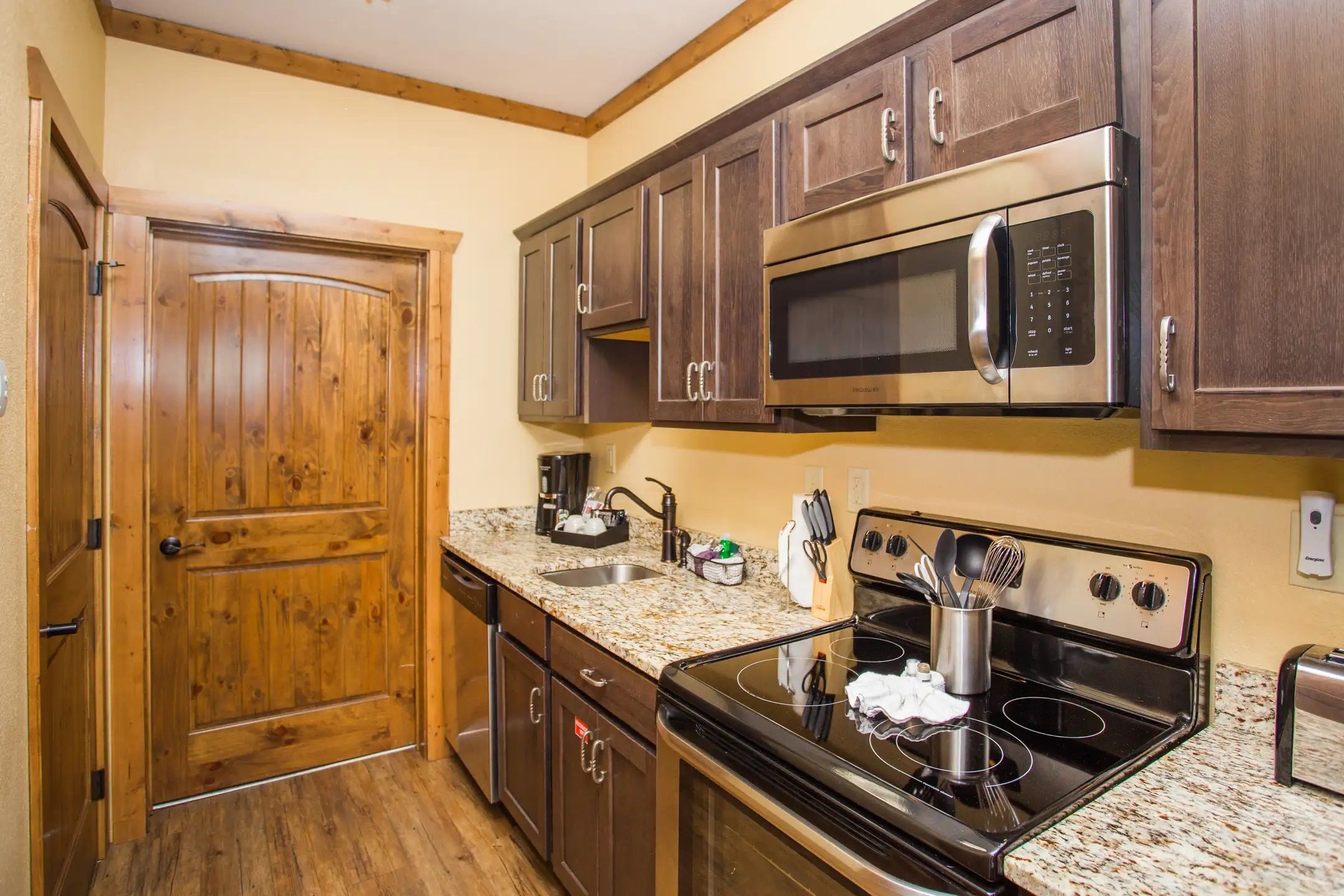 image Kitchen with stainless steel appliances and wood cabinetry.