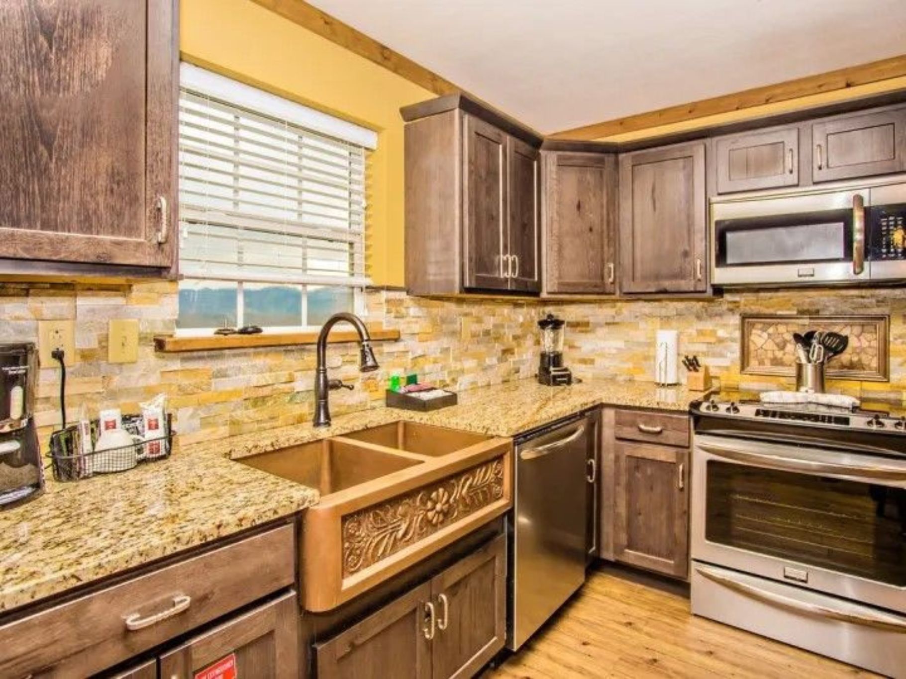 image Fully equipped kitchen with granite counters and stainless steel appliances.