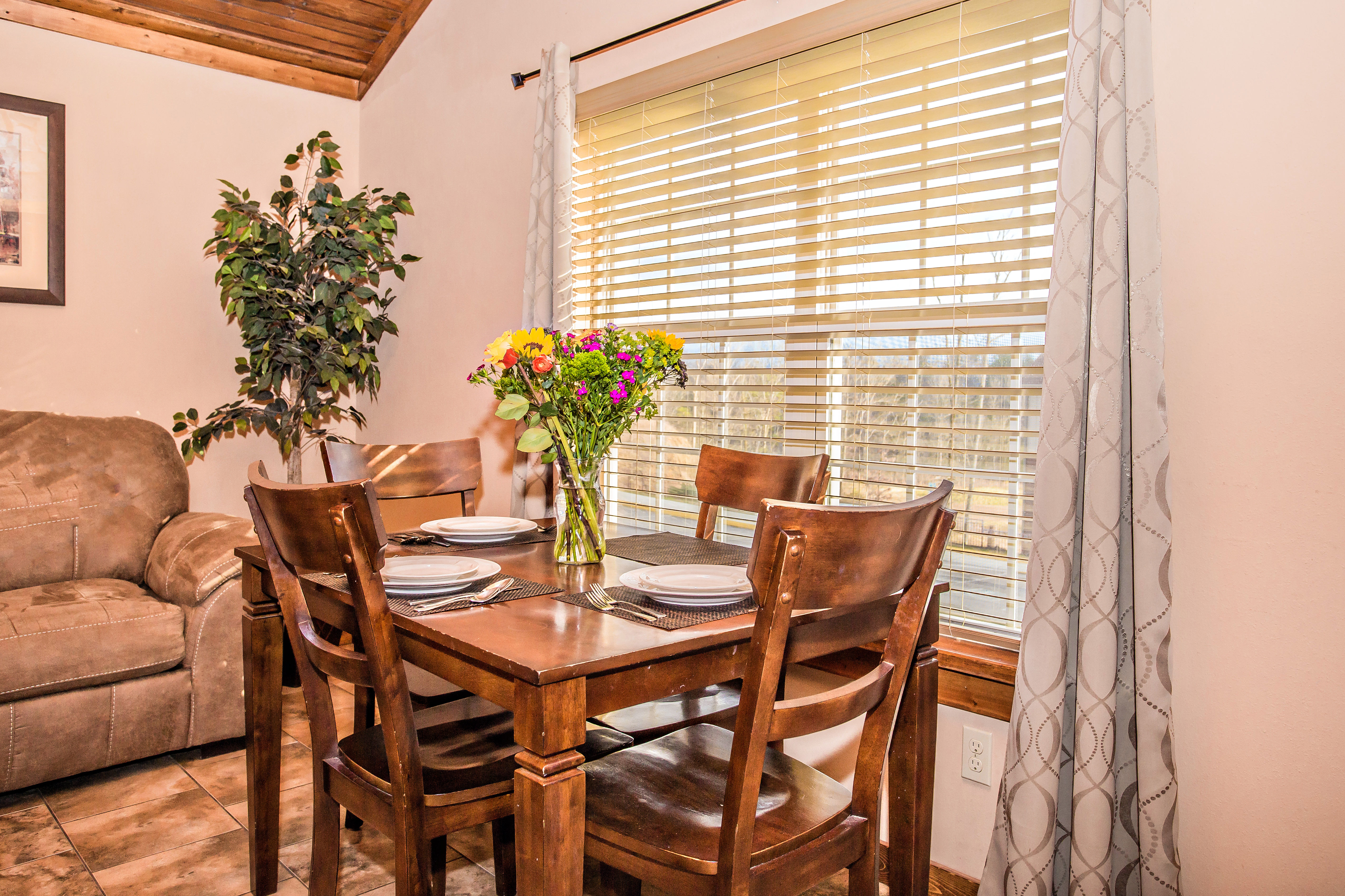 image Living and dining area with cozy seating and fireplace feature.