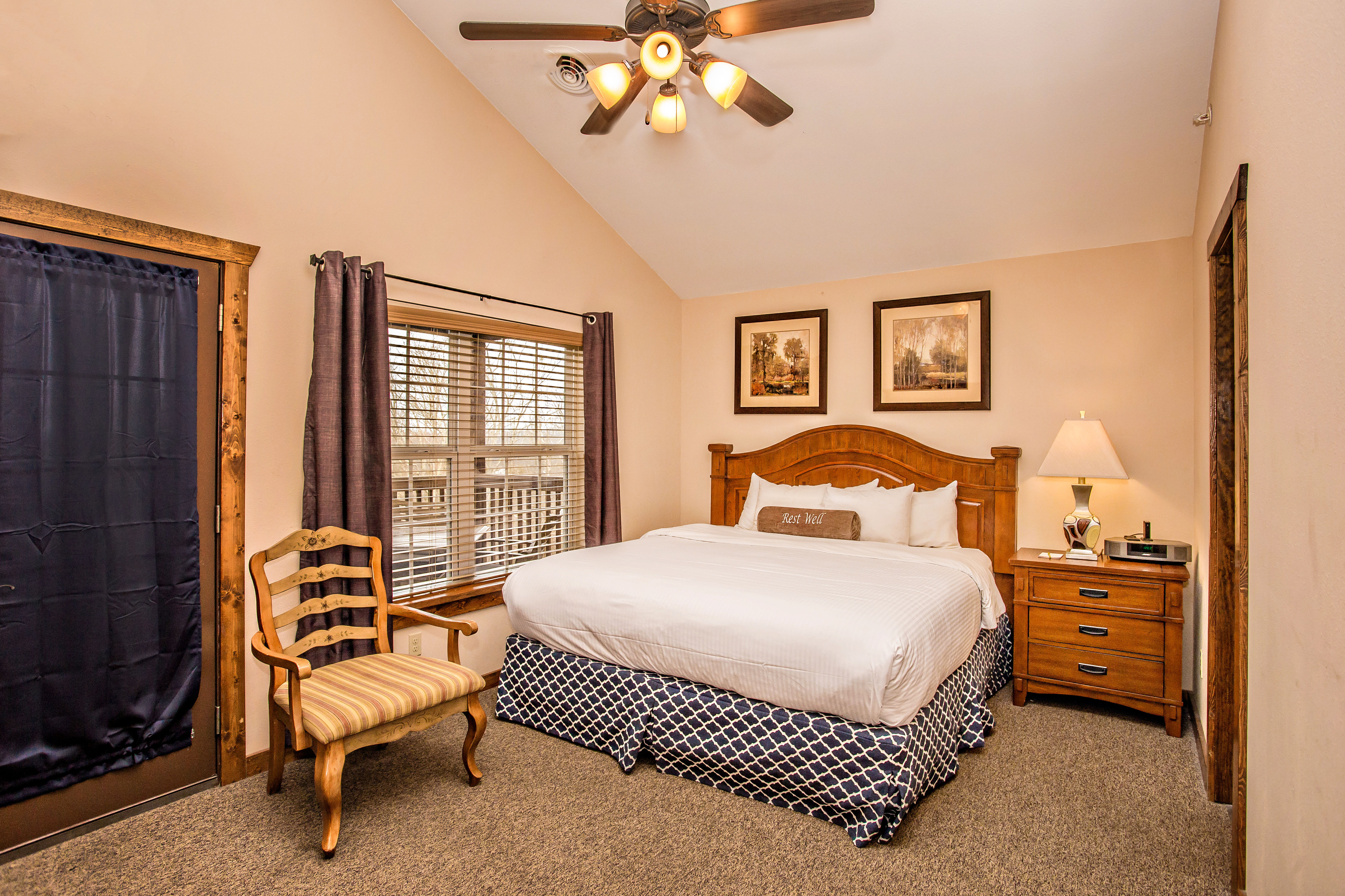image Bedroom with king bed, wooden furniture, and warm mountain-style decor.
