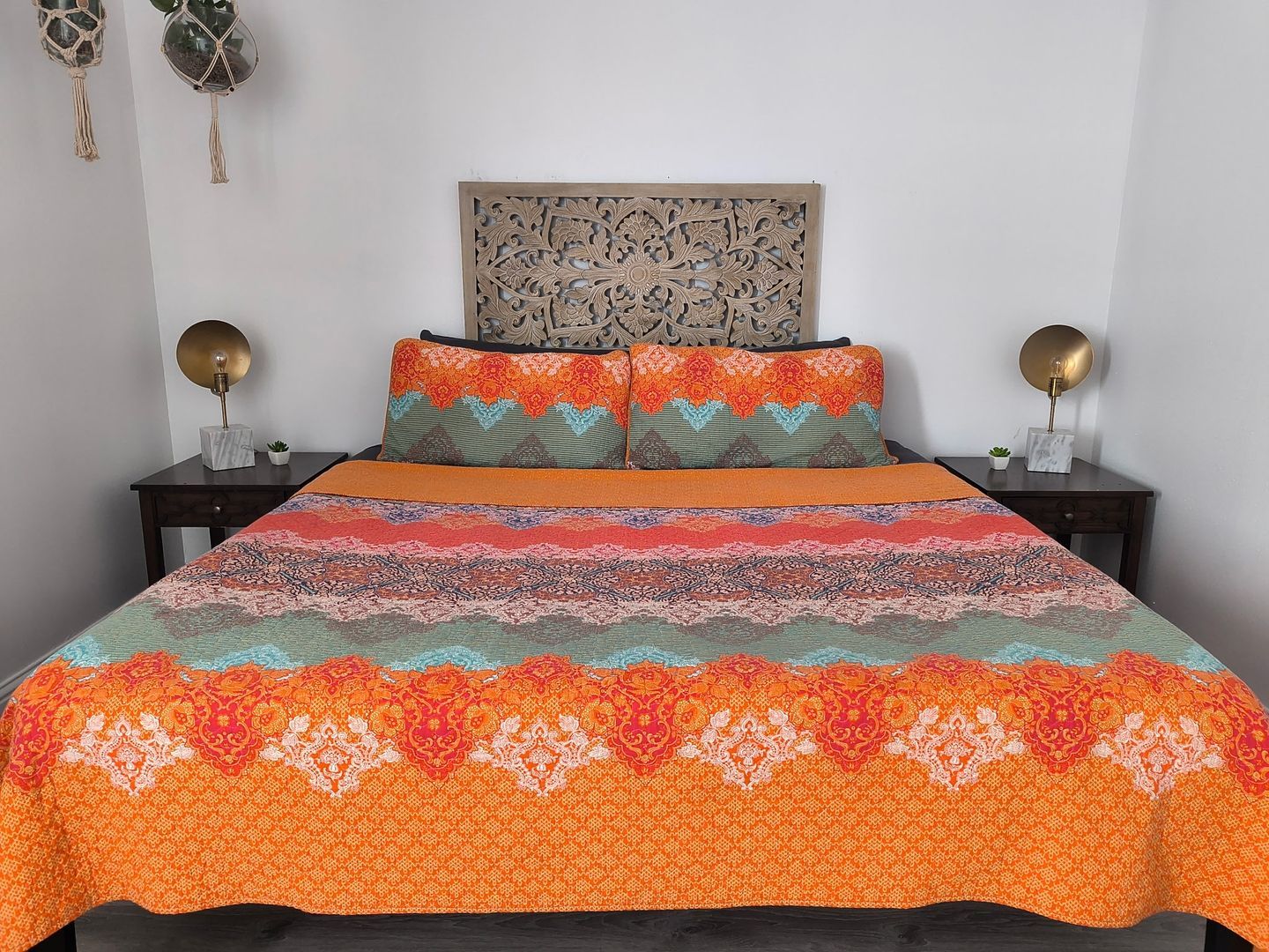 image The inviting bedroom boasts a colorful queen bed with elegant nightstands, creating a warm and relaxing retreat.