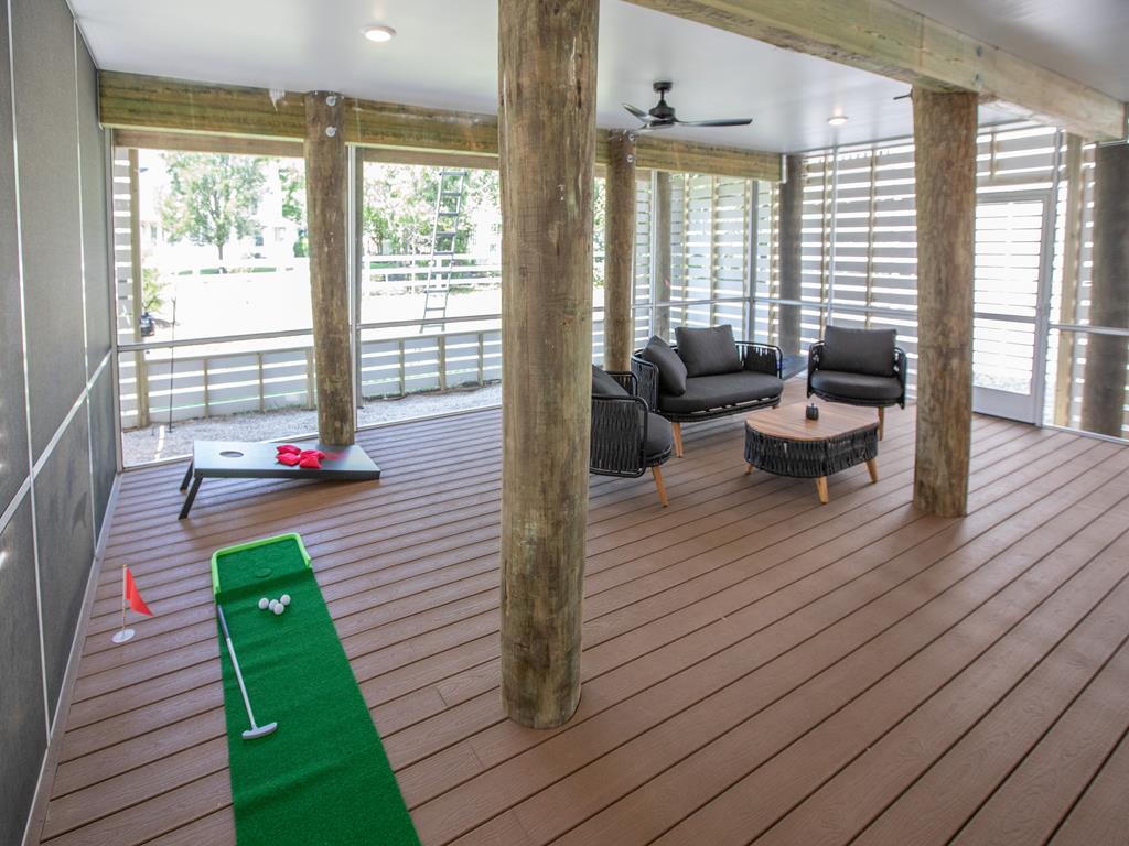 image Covered outdoor lounge doubles as a fun mini-golf area—great for kids and adults alike.