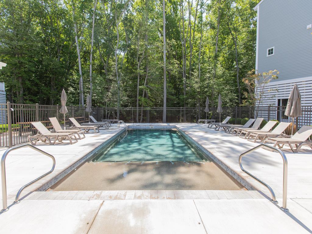 image Refresh and unwind in the community pool, surrounded by peaceful wooded views.