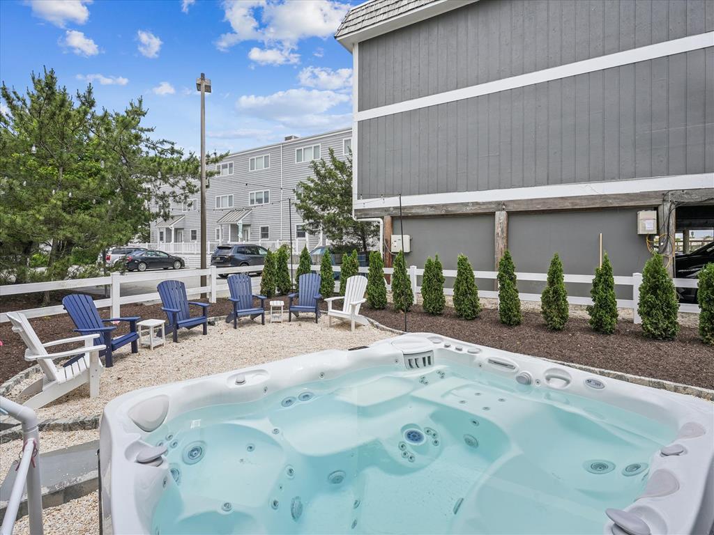 image Take a soothing soak in the spacious 8-person saltwater hot tub, nestled in a beautifully landscaped backyard retreat.