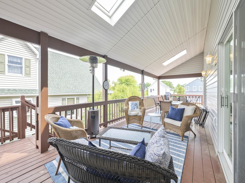 image Covered porch with cushioned seating—perfect for sipping wine or reading a book in the breeze.