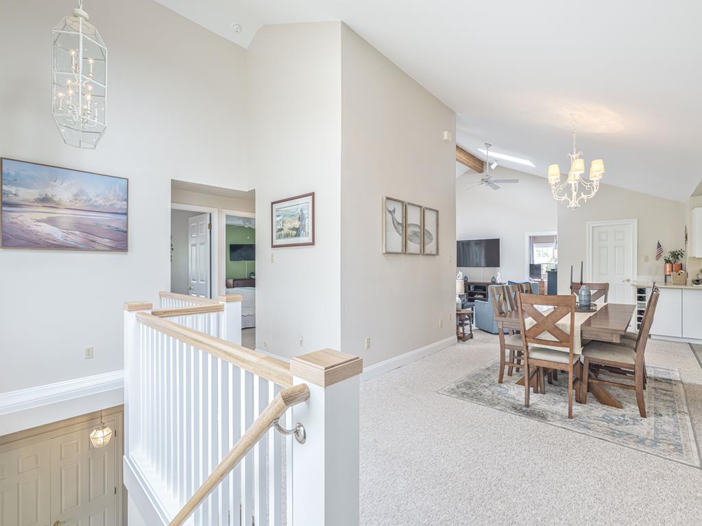 image Open landing area leading to dining and living spaces, showcasing the home's airy layout and flow.