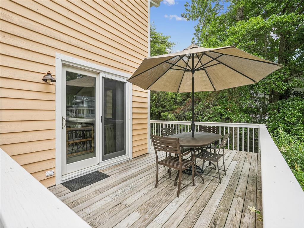 image Enjoy al fresco dining on the back deck with umbrella-shaded seating.