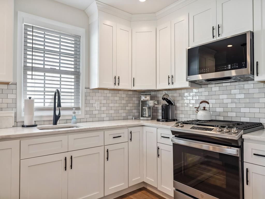 image The stylish kitchen shows sleek countertops, modern appliances, and ample cabinetry for a functional yet elegant design.