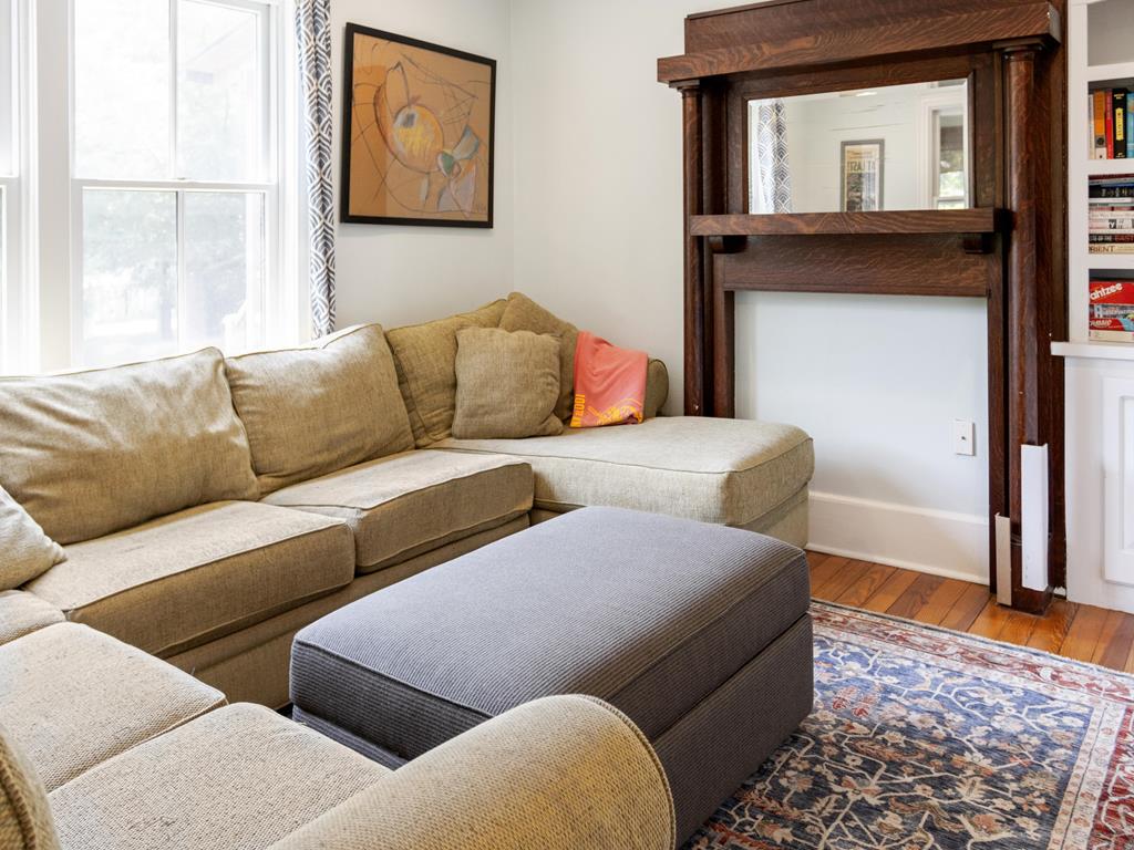 image A warm living area filled with natural light, showcasing a large sectional sofa and decorative elements.