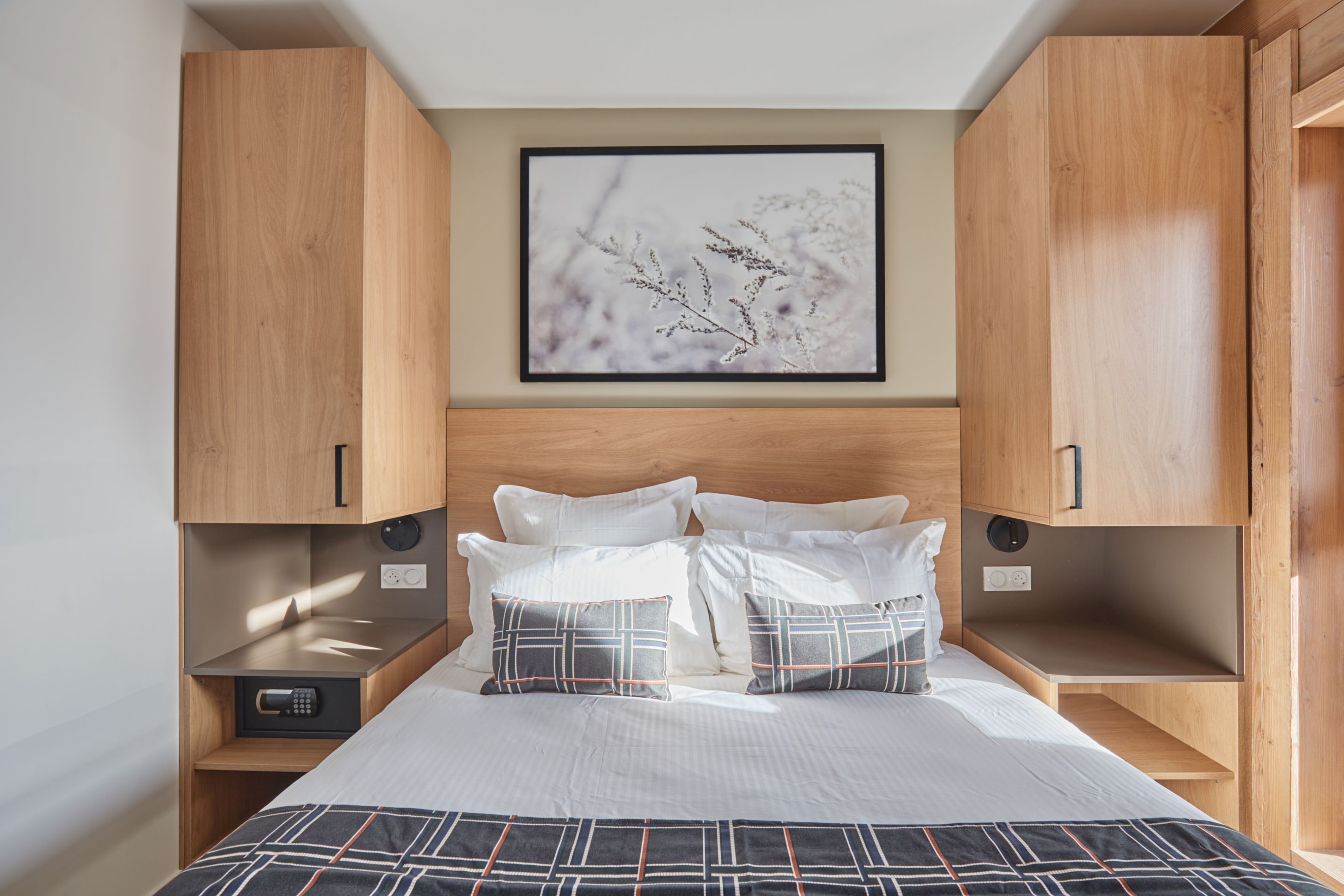 image Double bedroom with wooden headboard, white pillows, and warm earth-tone walls — bed linen included in every stay.