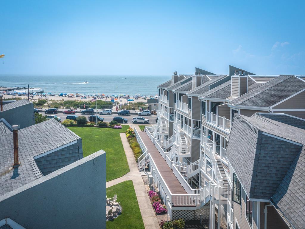 image Balcony-level perspective overlooking a landscaped courtyard and expansive ocean views.