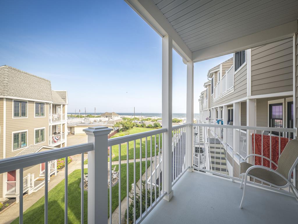 image Private balcony with peekaboo ocean views and cozy seating.
