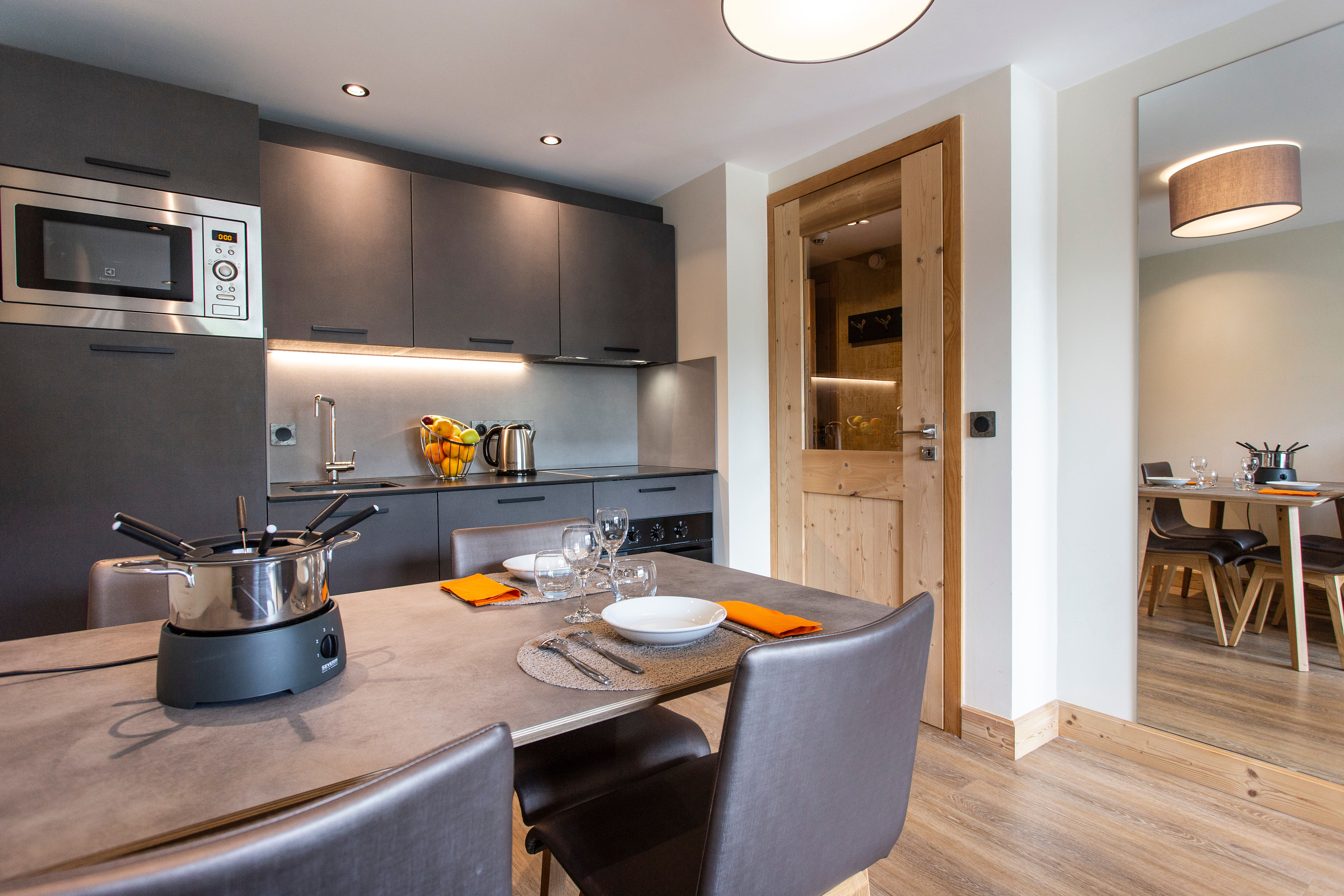 image The sleek kitchen showcases contemporary appliances and ample counter space, making it an ideal setting for family meals and gatherings after a day on the slopes.