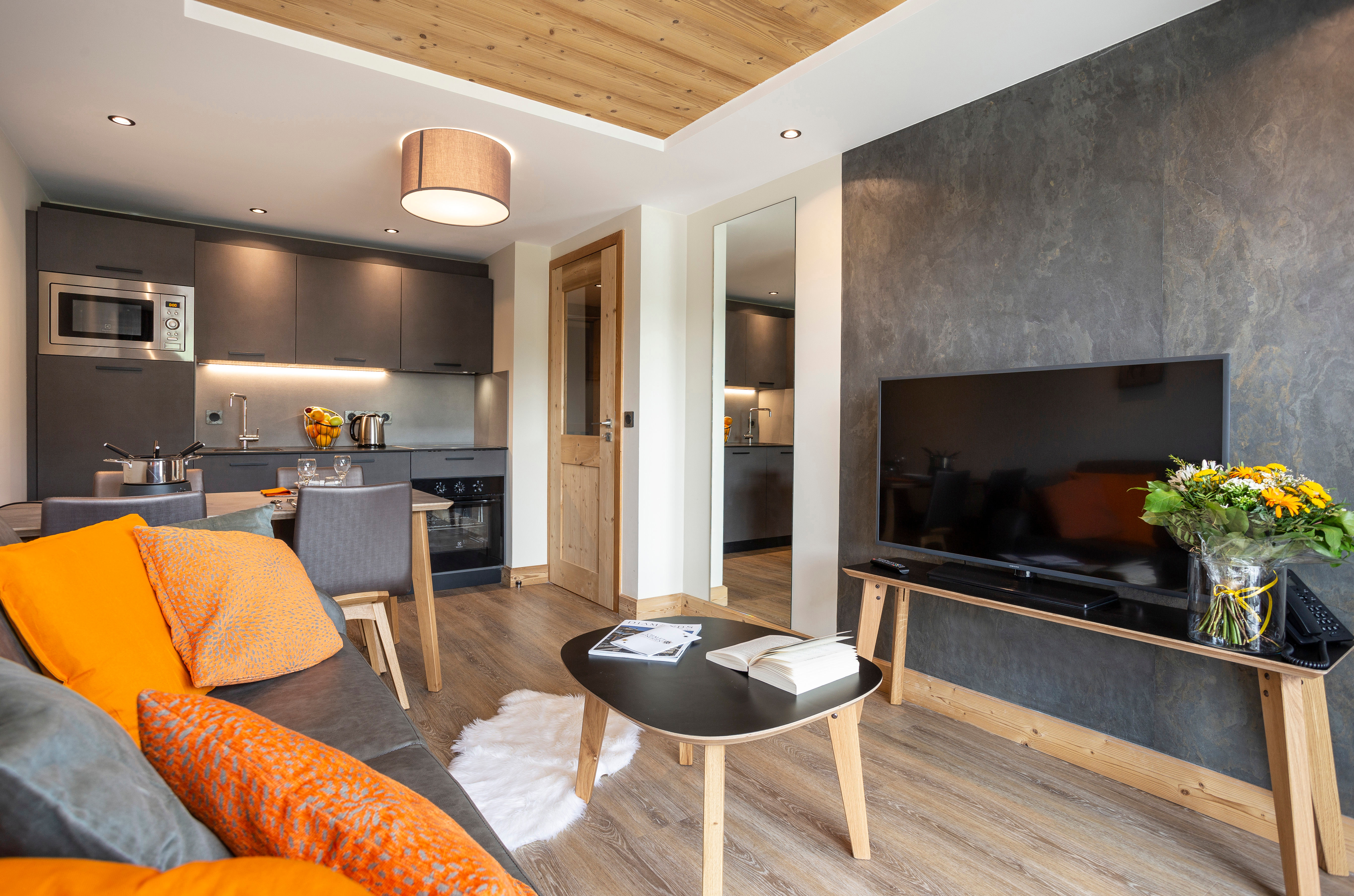 image A spacious combined living and dining area highlights a harmonious blend of style and comfort, featuring a stylish television setup and decor that invites relaxation after outdoor adventures.
