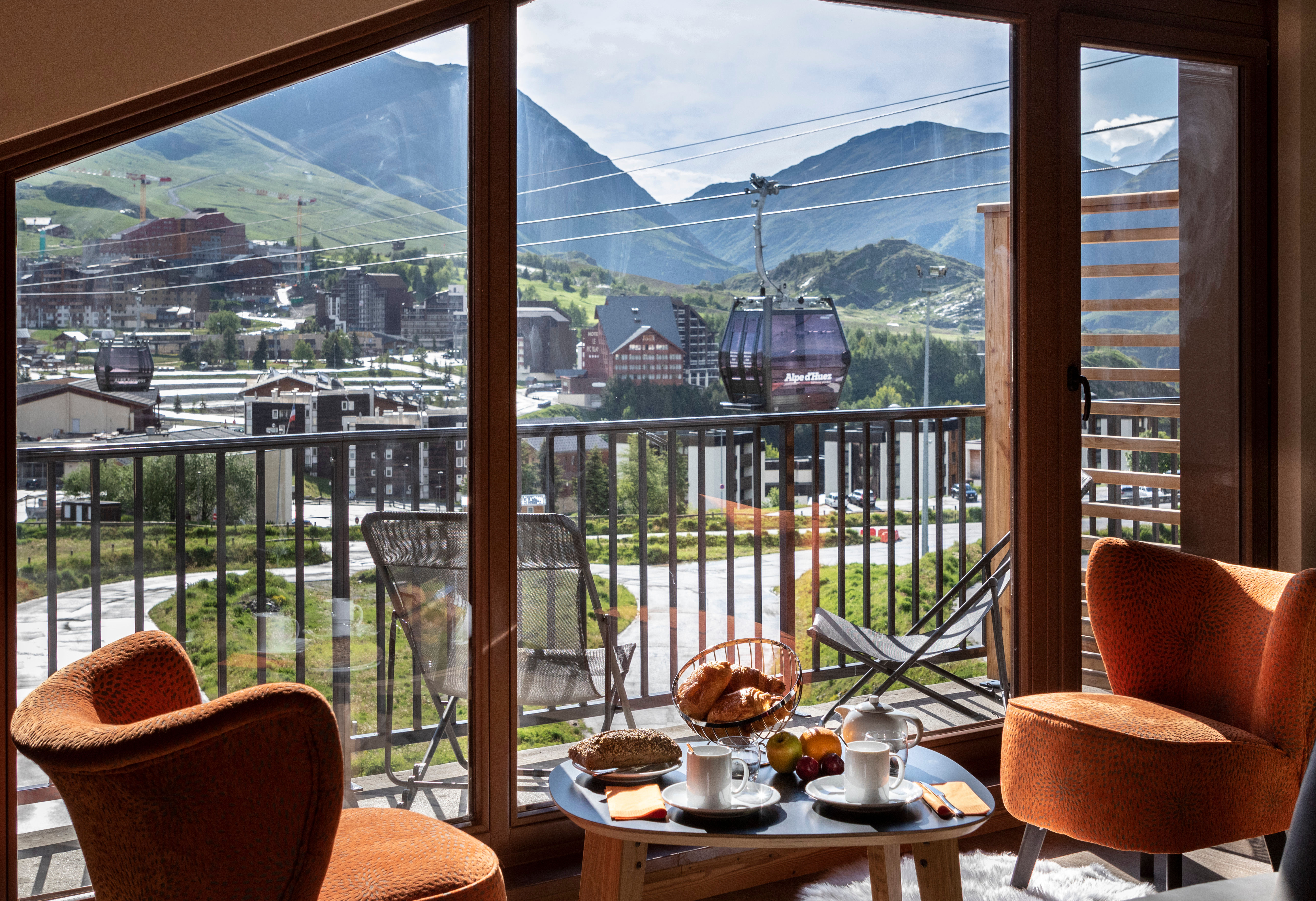 image Wake up to panoramic alpine vistas from your private balcony set for a peaceful morning coffee.