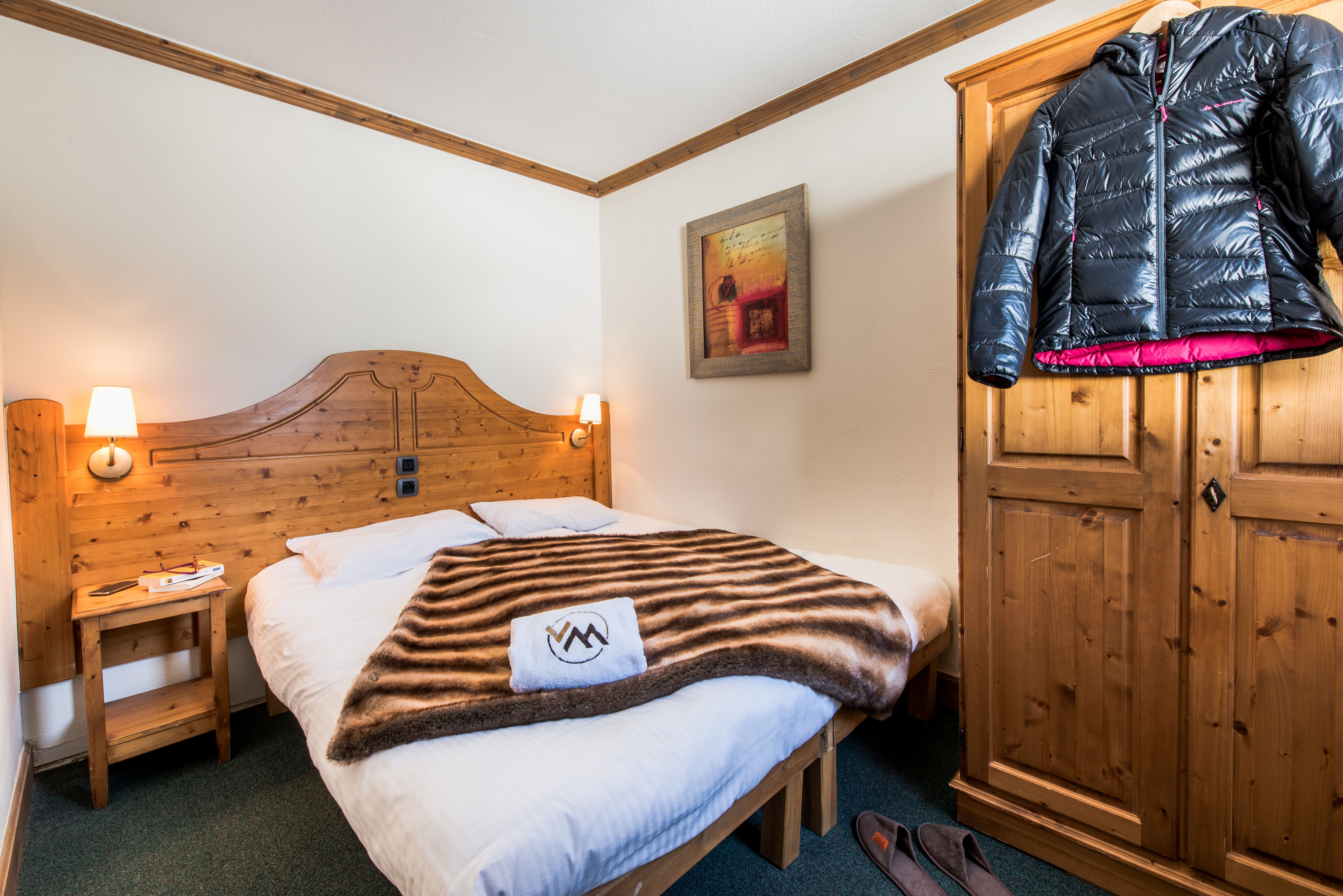 image Bright double bedroom with warm wood tones and mountain charm.
