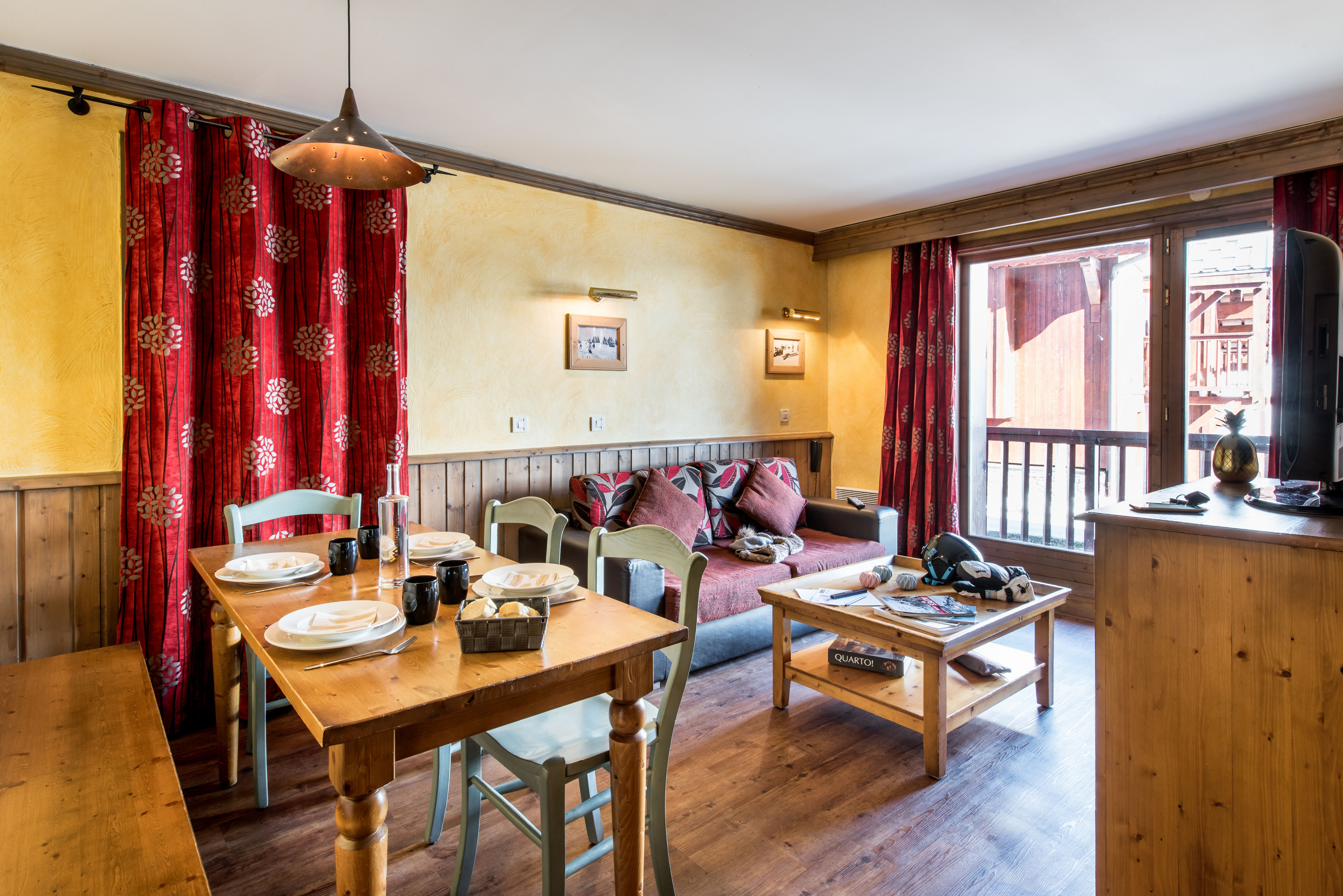 image Comfortable living room with balcony access and plenty of natural light for relaxed alpine stays.