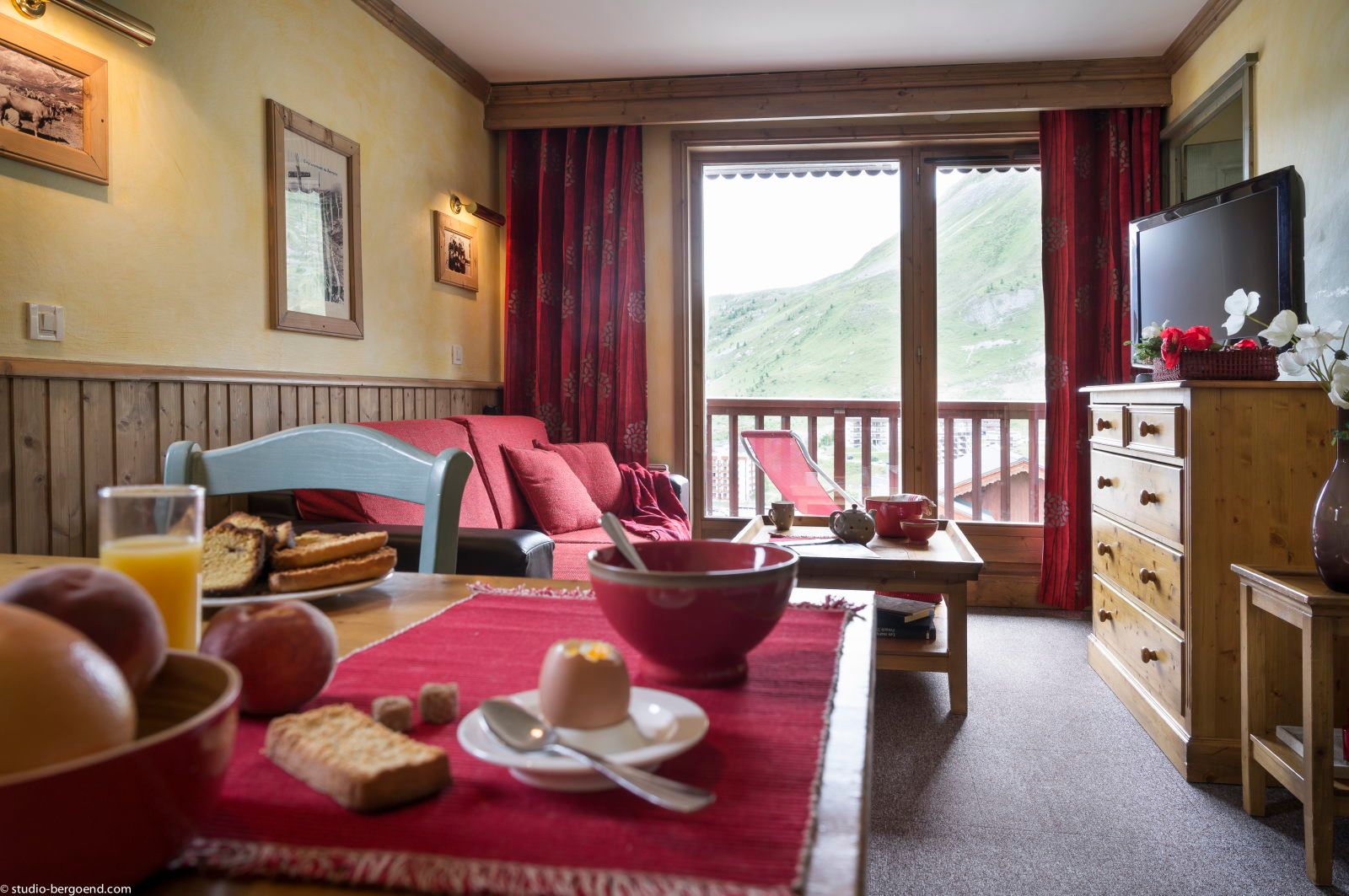 image Dining area with a breakfast spread laid out and mountain views framed by large windows