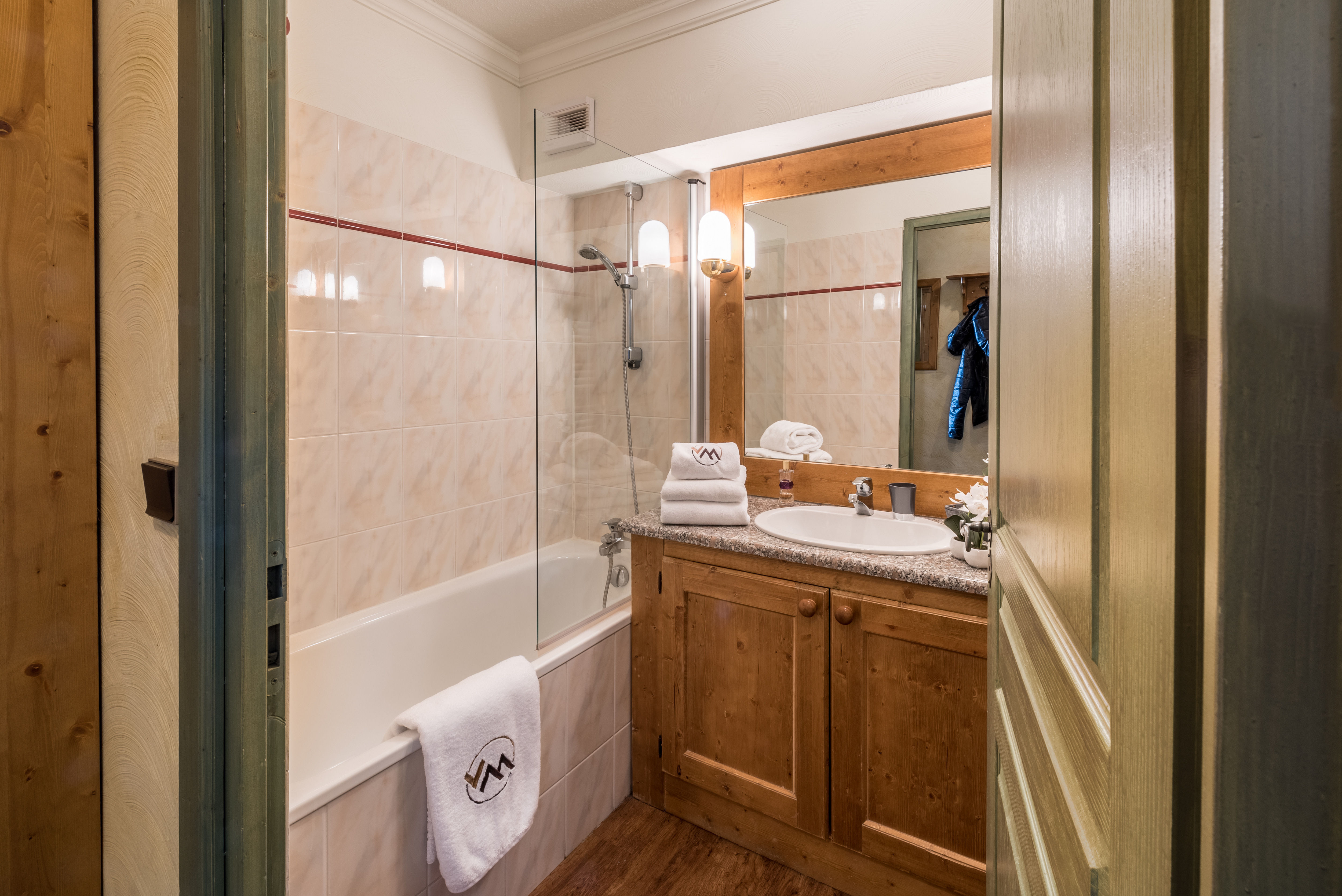 image Spacious bathroom with full-size tub and generous counter space for shared use.