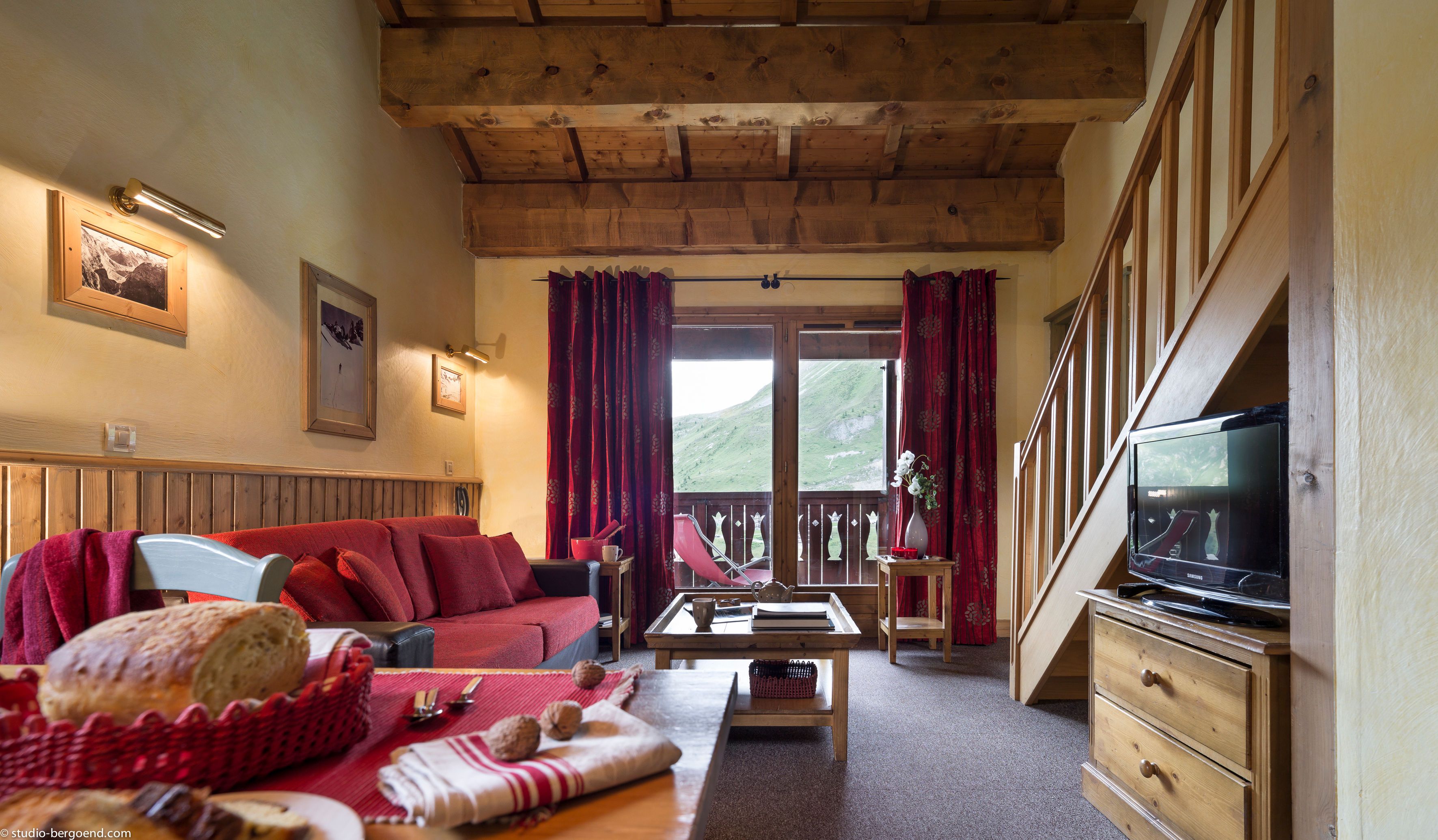 image The bright lounge area features warm wood accents, comfortable seating, and balcony access.
