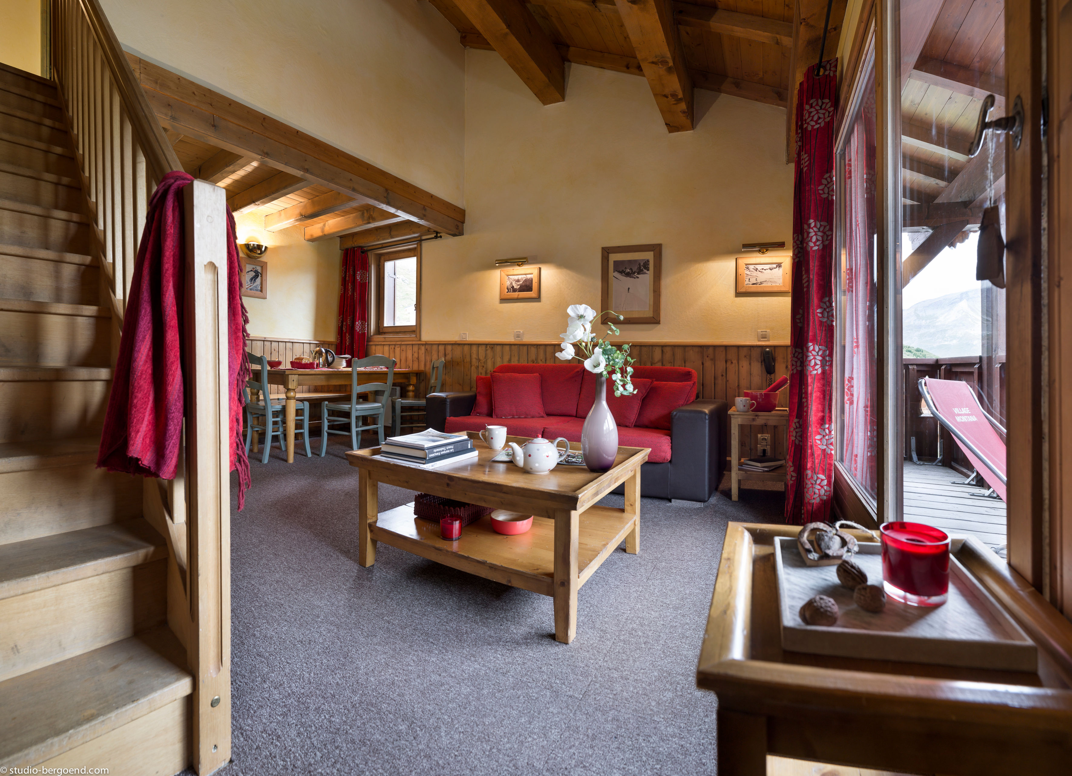 image Open-plan living with cozy alpine decor and a mezzanine layout perfect for families.
